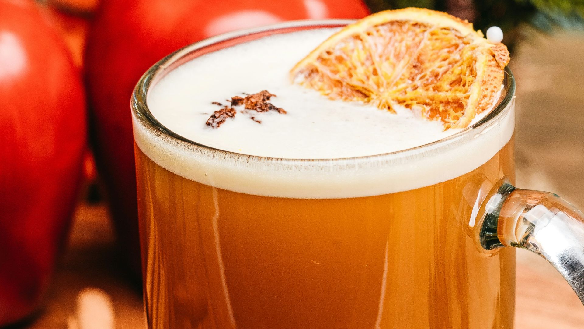 a glass of tea with lemons and a slice of lemon