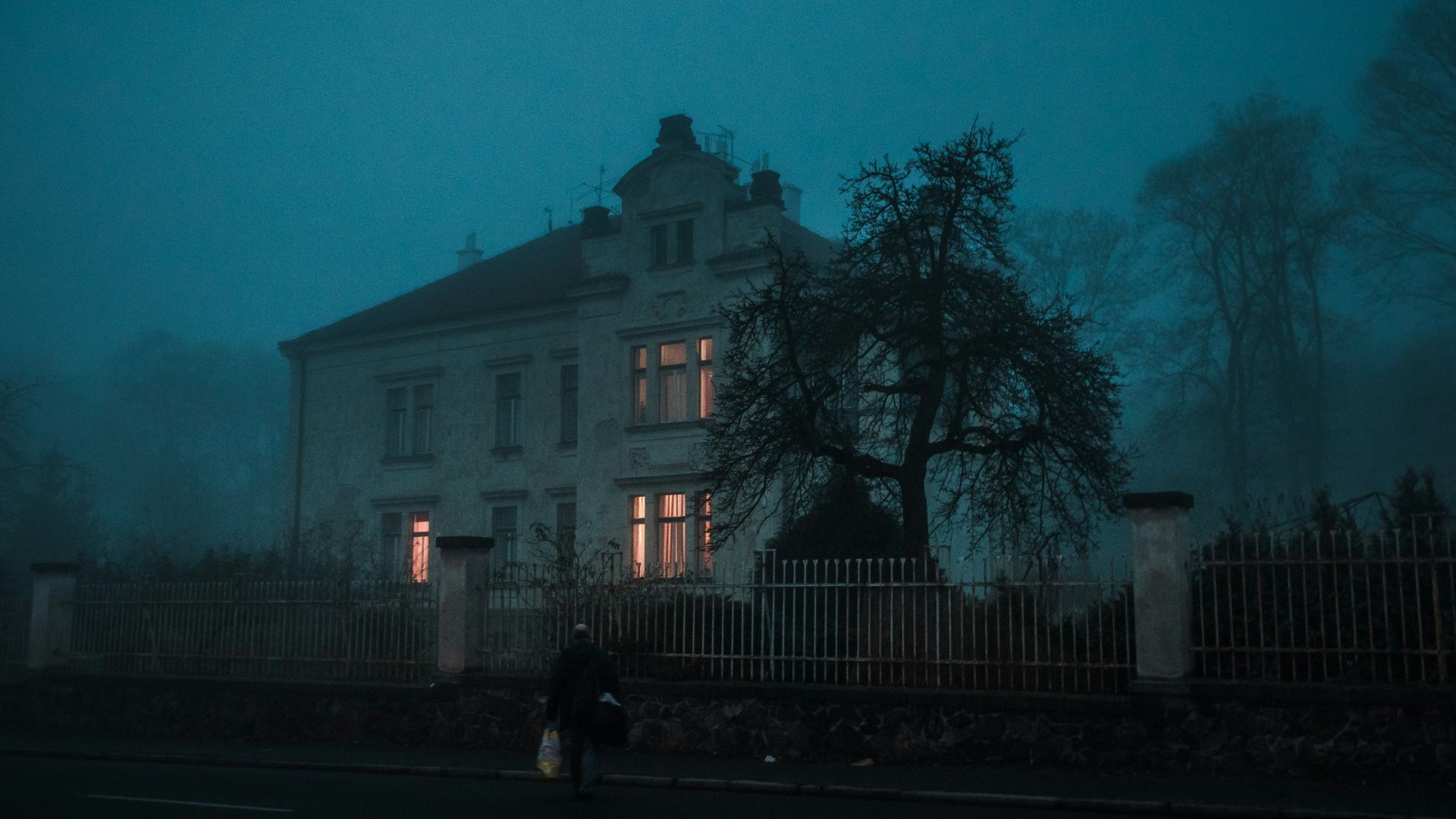 person walking towards house