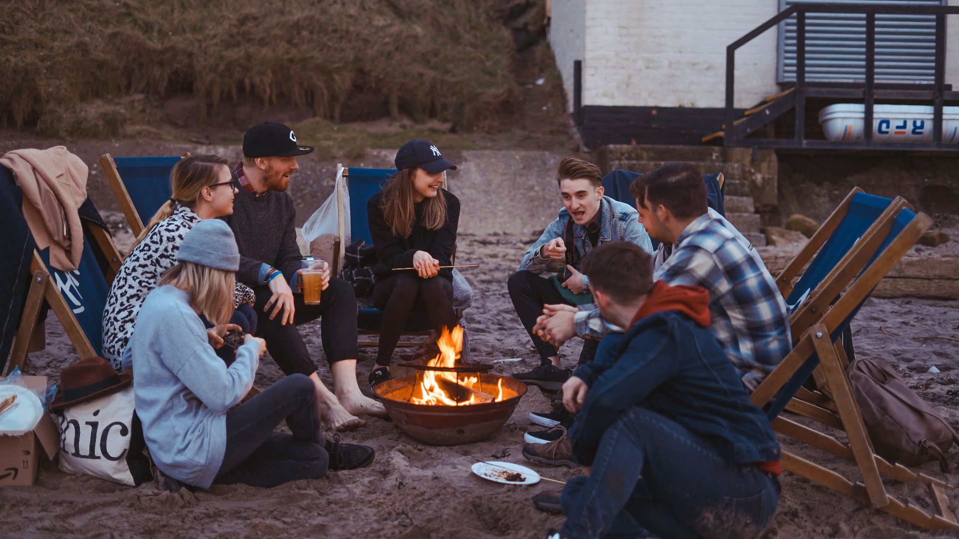 group of people sitting on front firepit