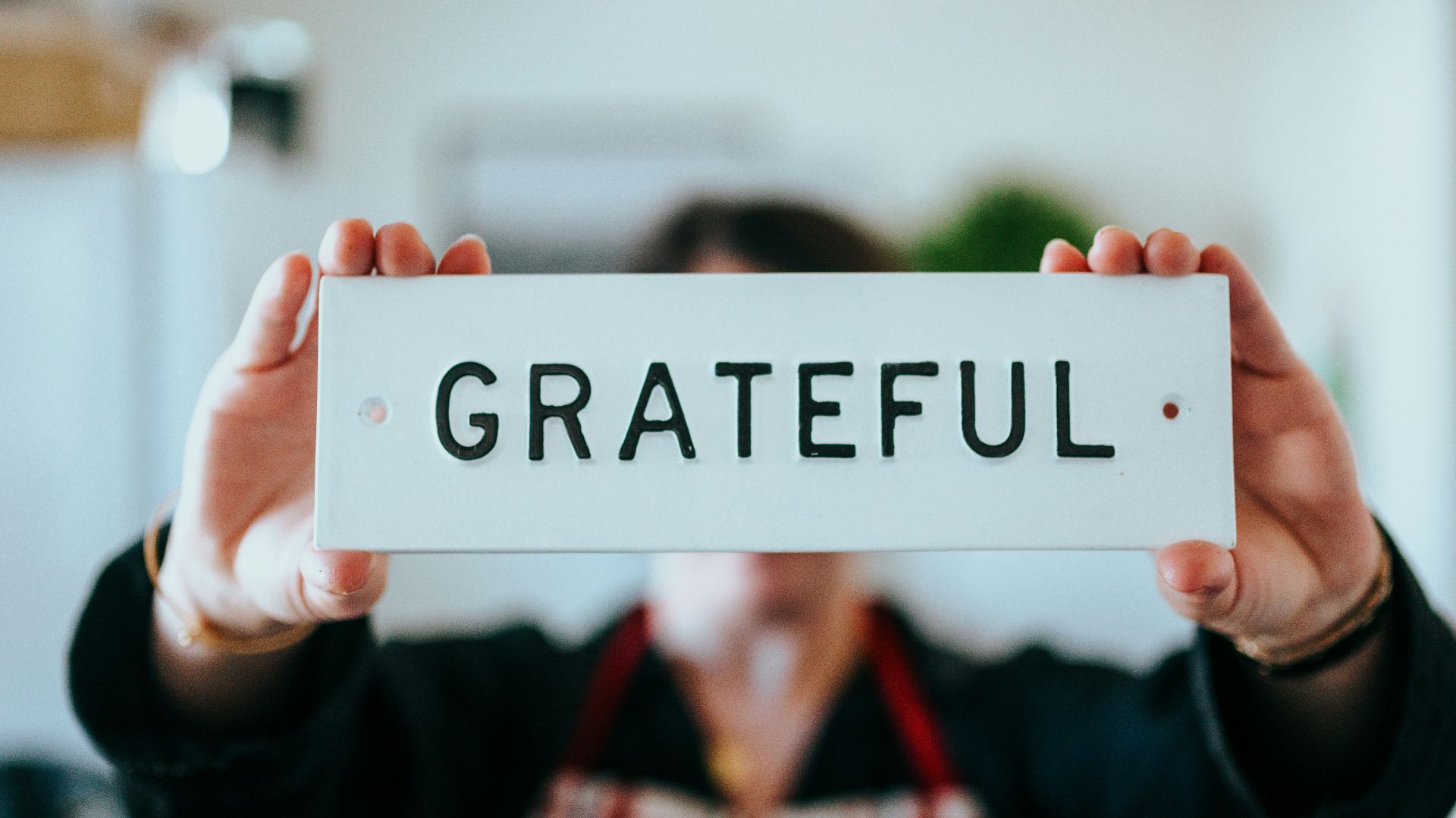 person holding white and black i love you print card