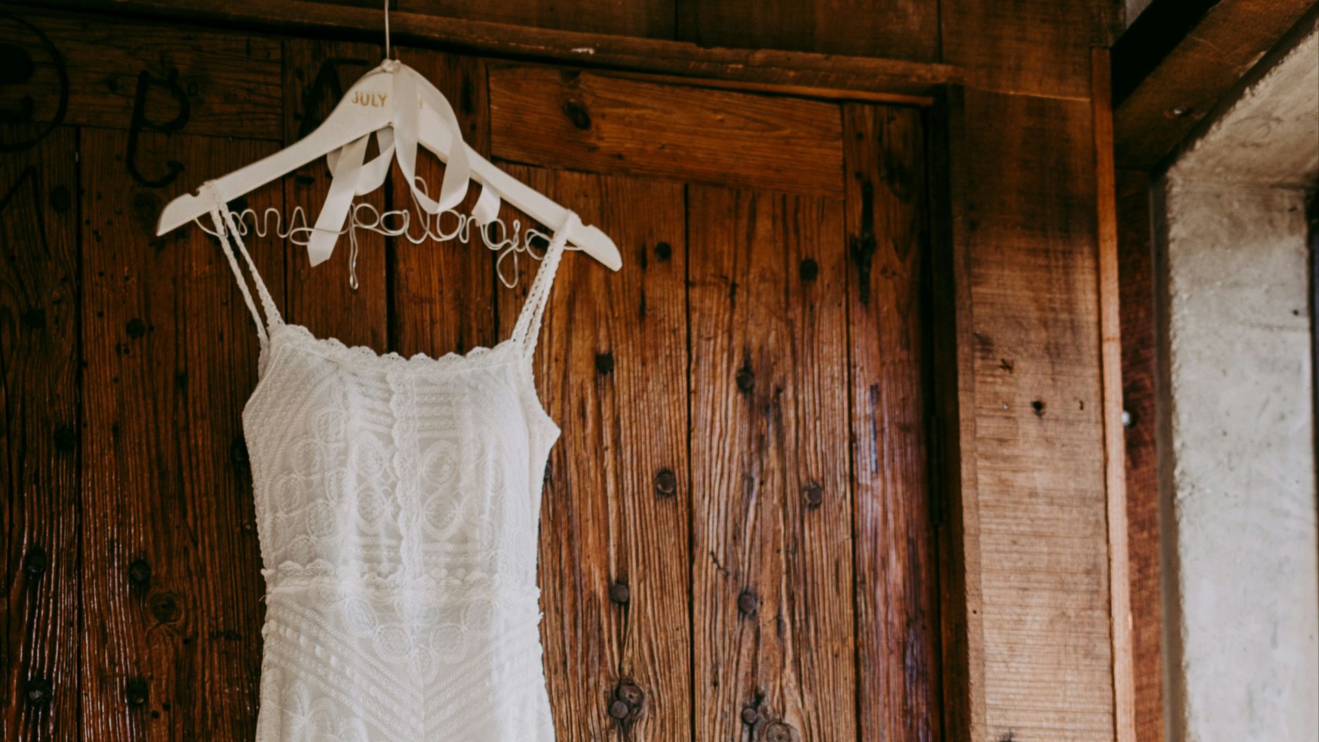 white sleeveless dress near brown wooden door