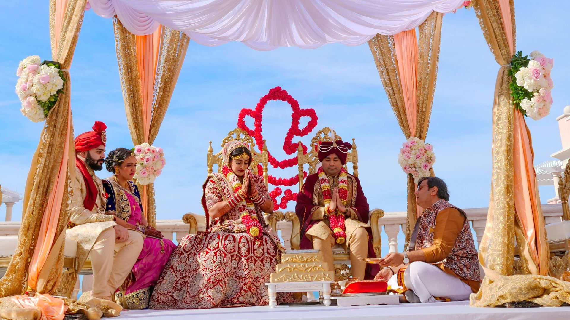 people sitting on chair under red and white floral umbrella