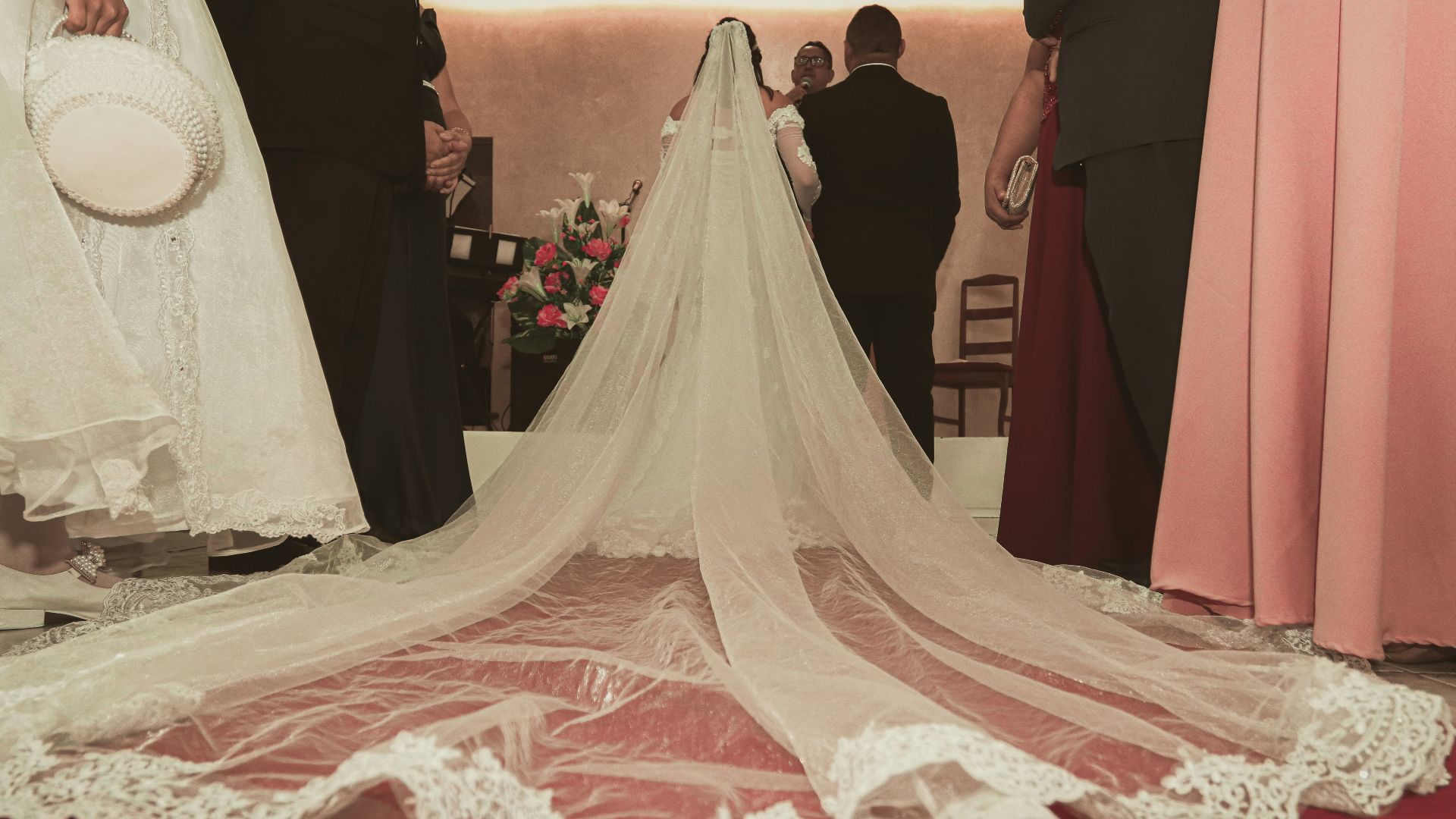 woman in white wedding gown standing beside man in black suit