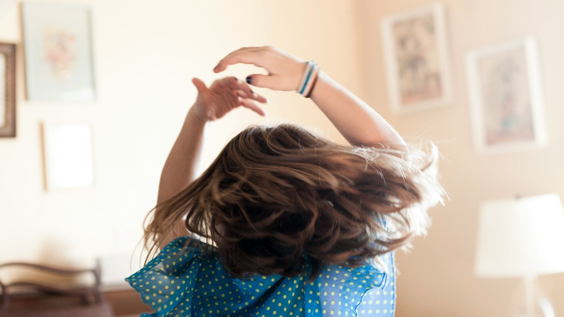 girl twirling around room