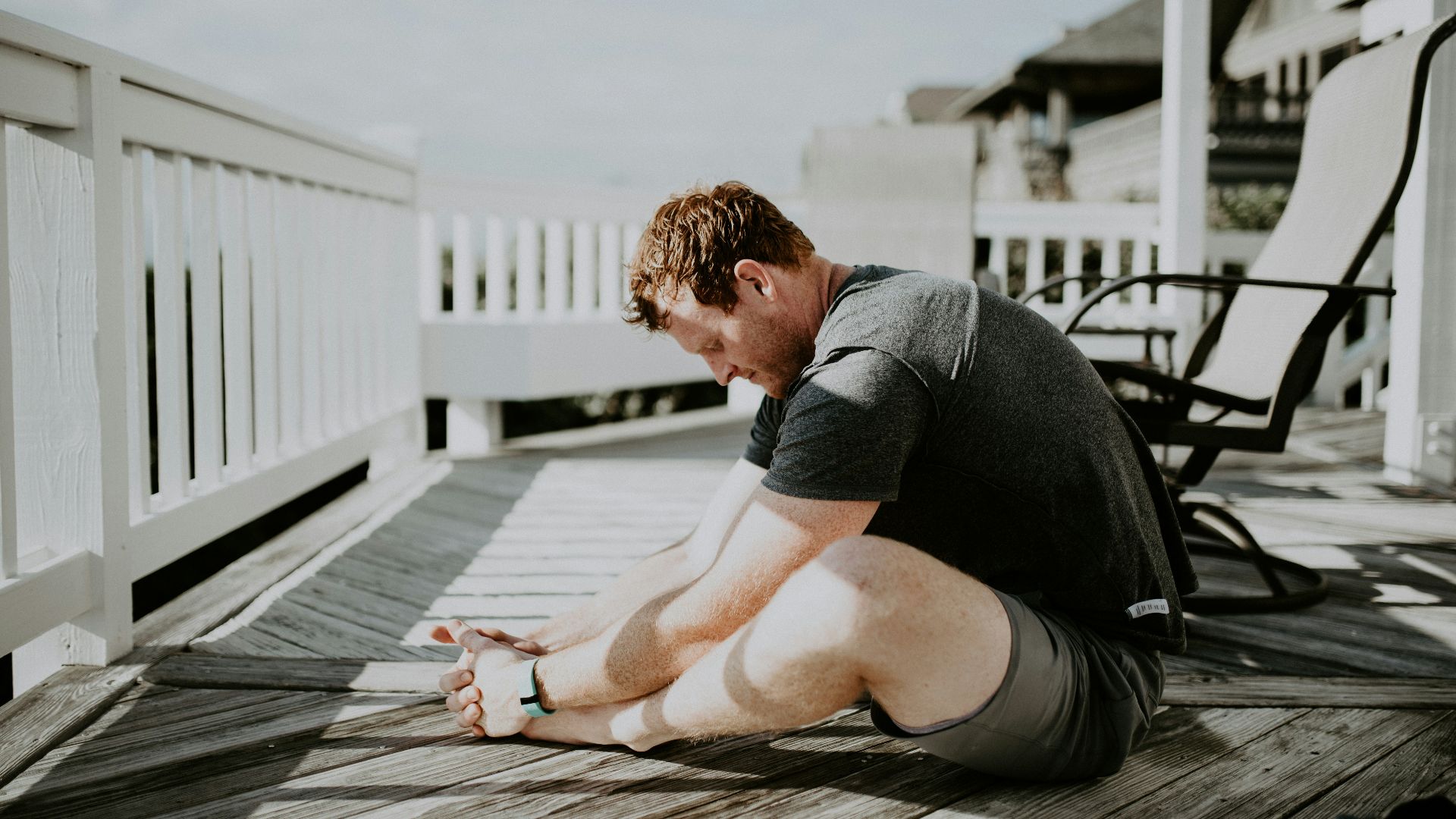 man doing yoga in porch