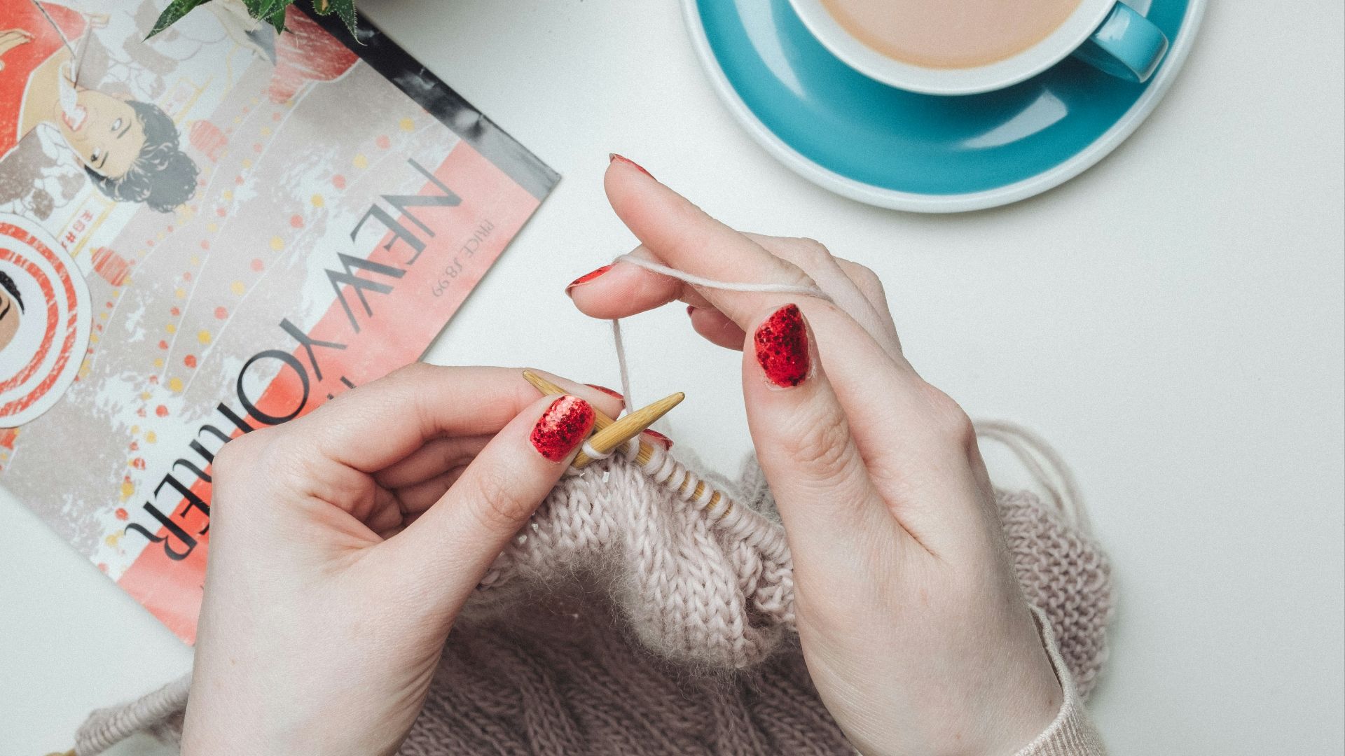 person knitting beige garment