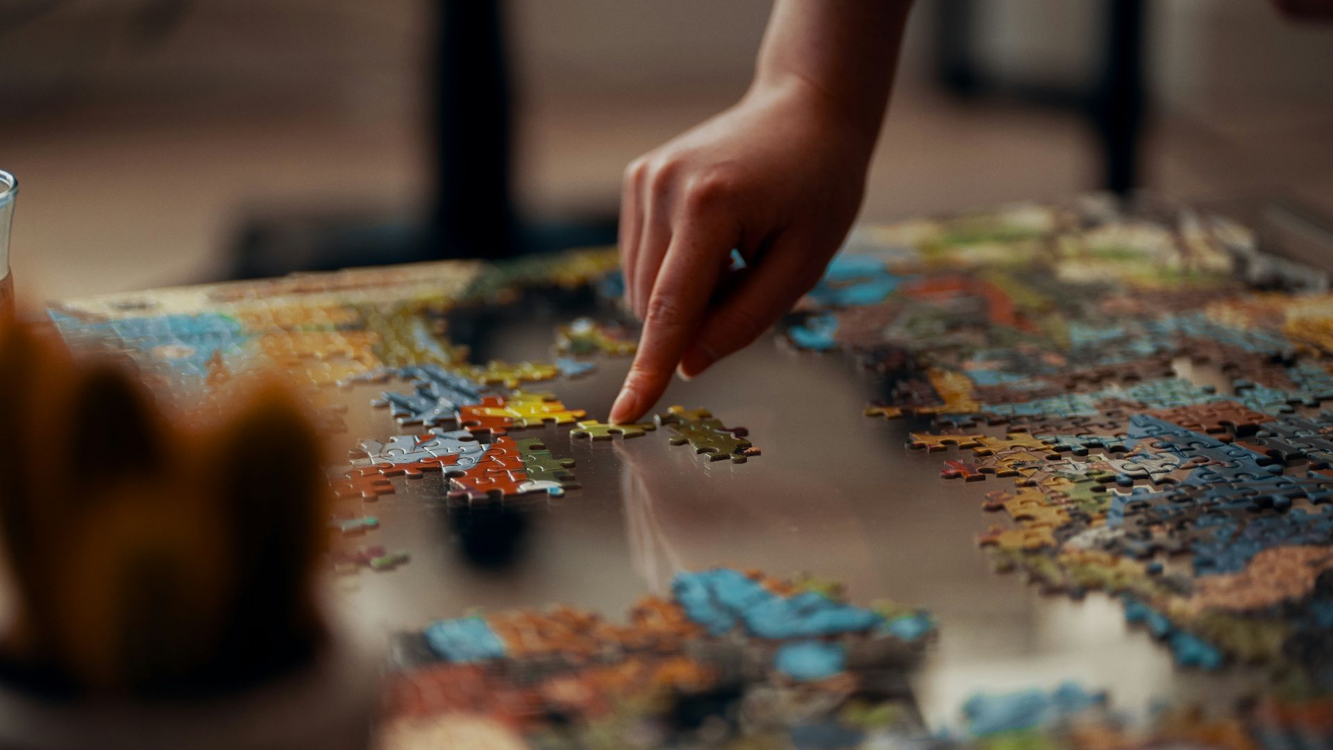 person holding jigsaw puzzle piece