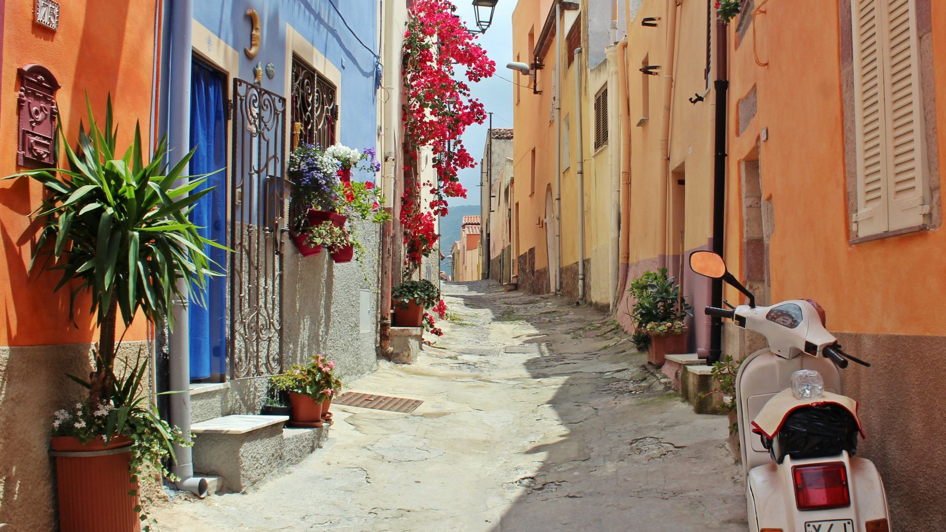 white motor scooter near building
