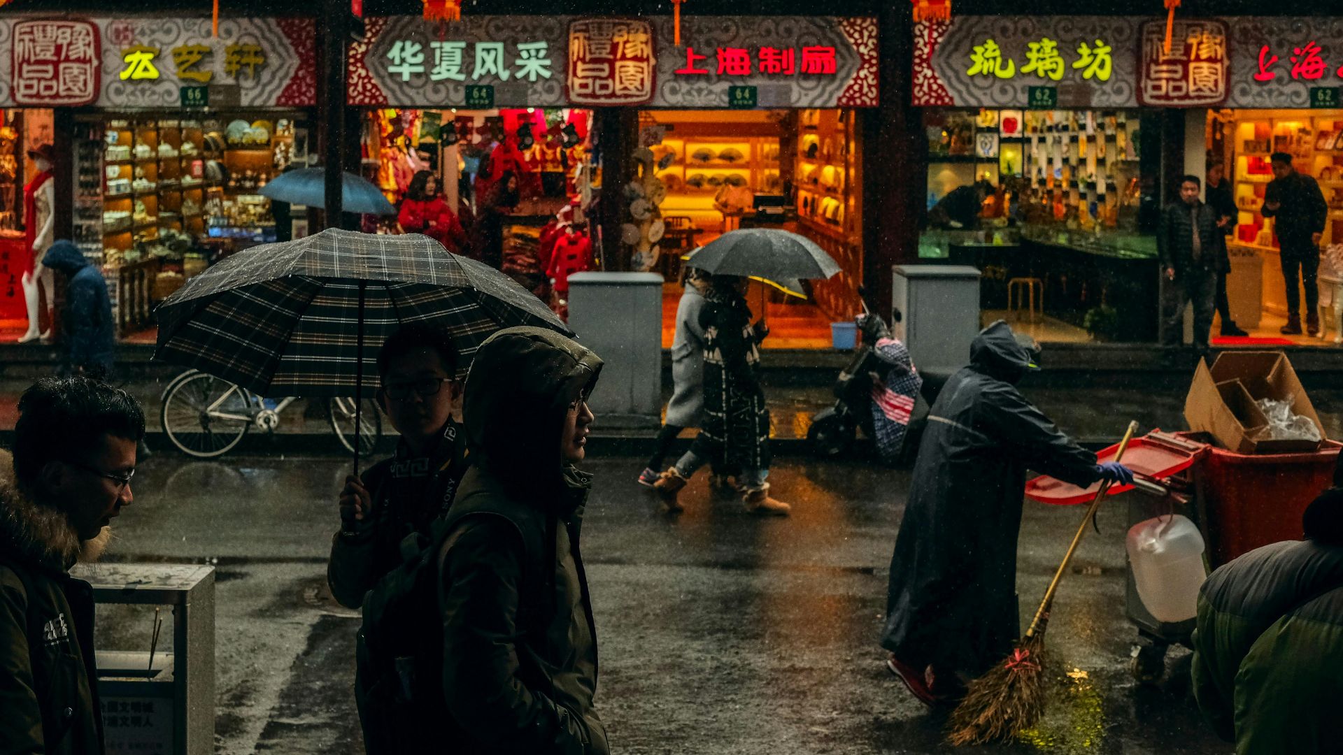 person carrying umbrellas