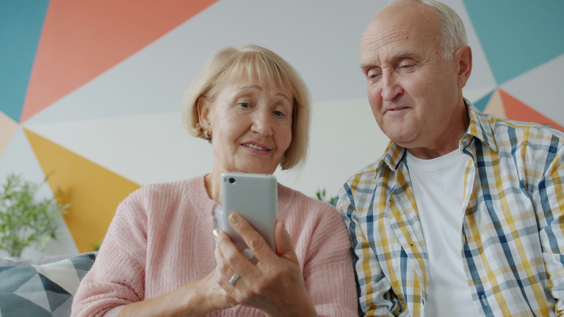 Elderly couple looking at a smartphone together on phone