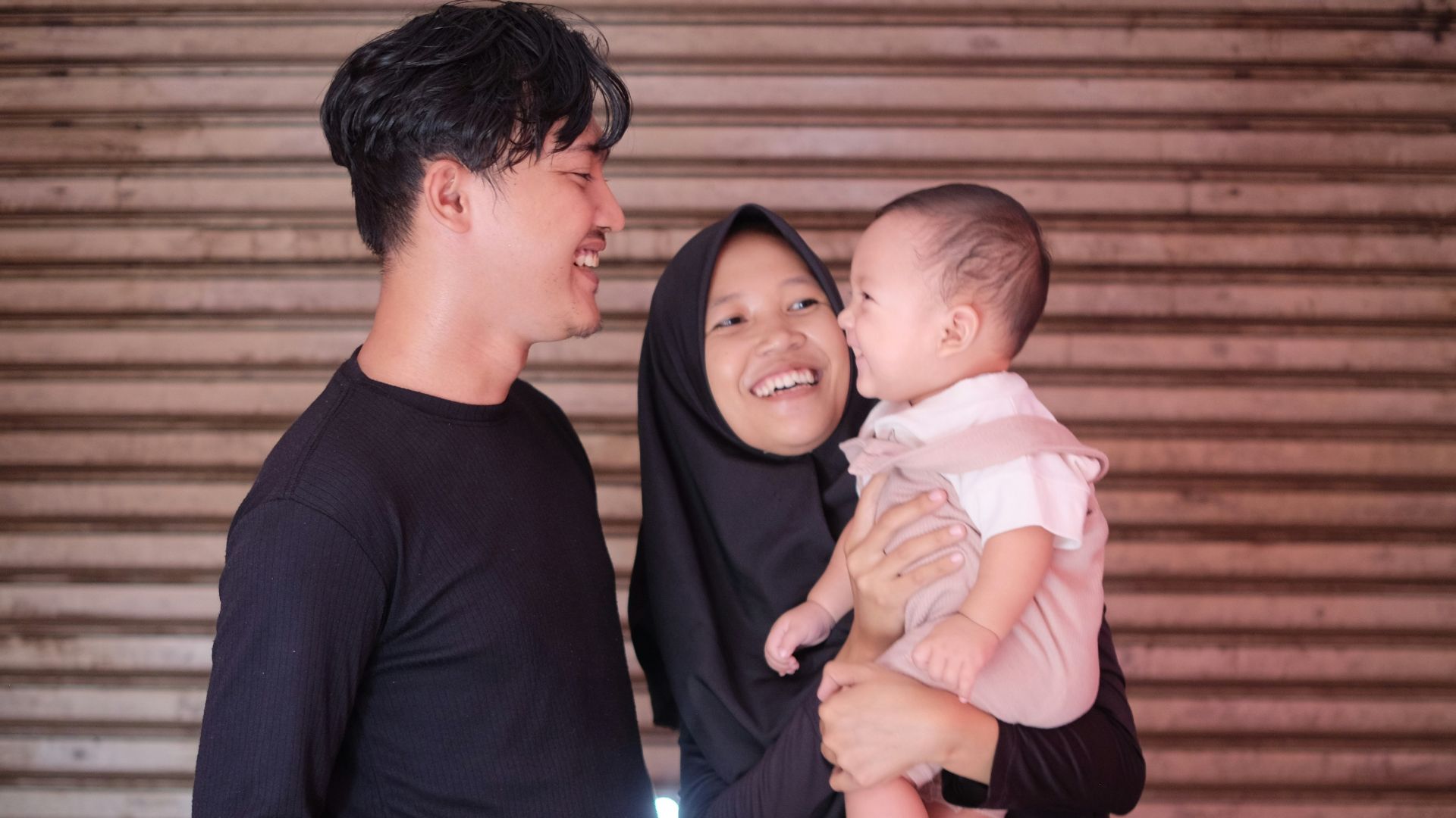 a man and a woman holding a baby