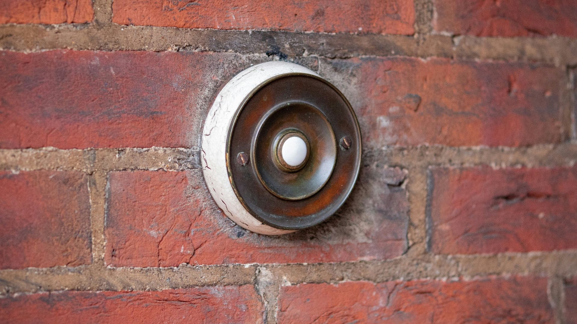 brown and black round metal on brown brick wall