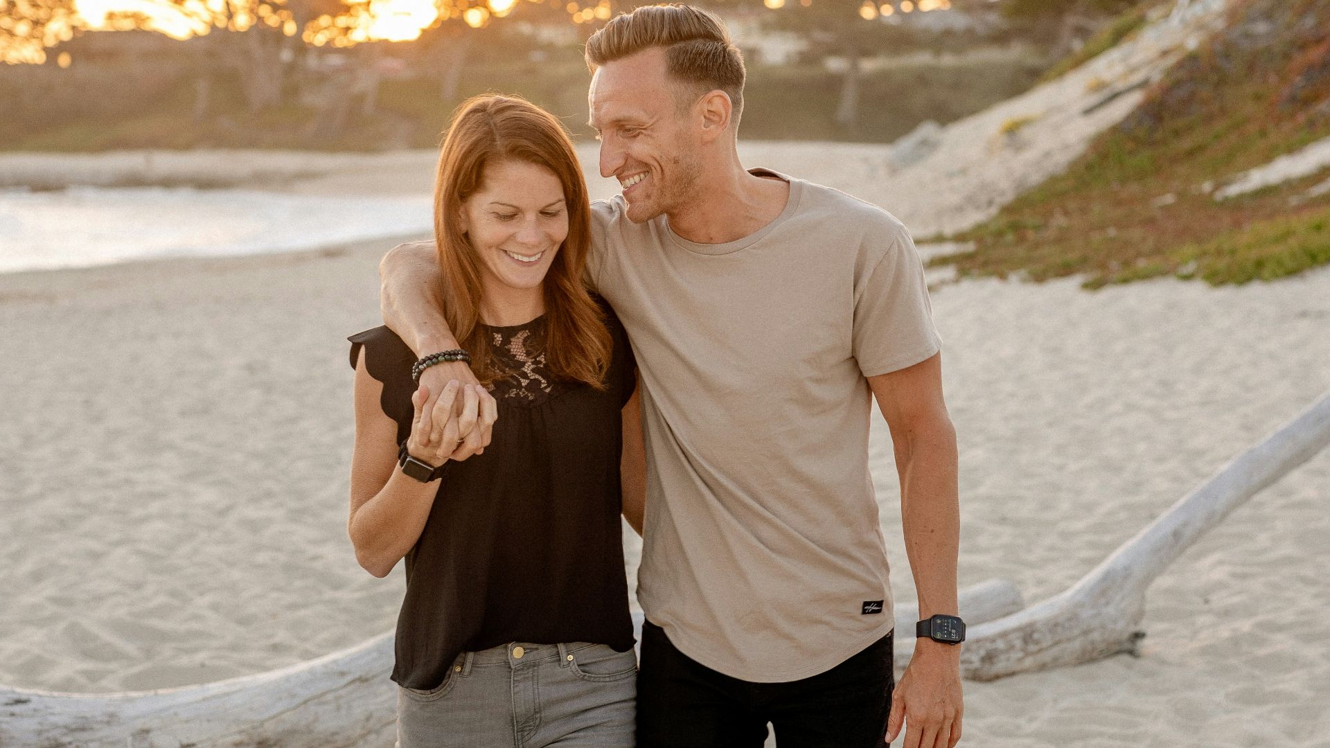 man and woman standing on beach during daytime