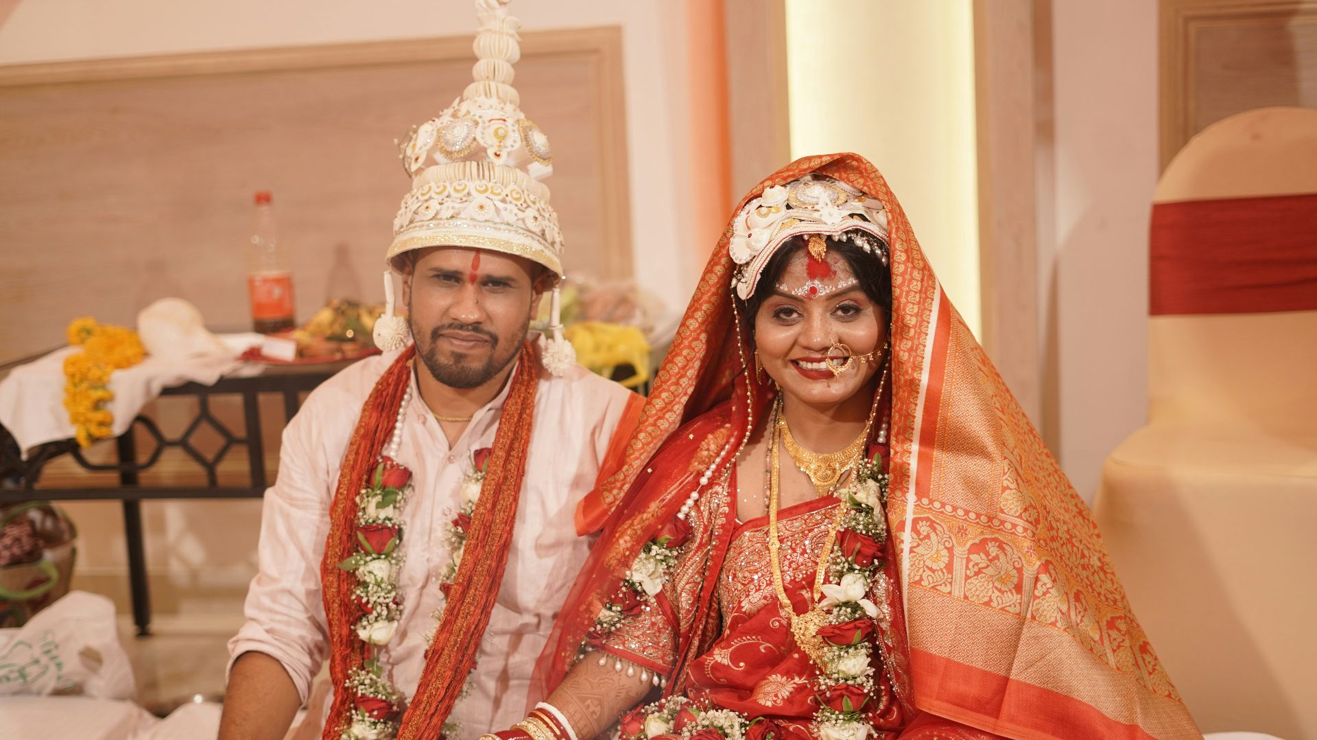 A couple smiles during a wedding ceremony.