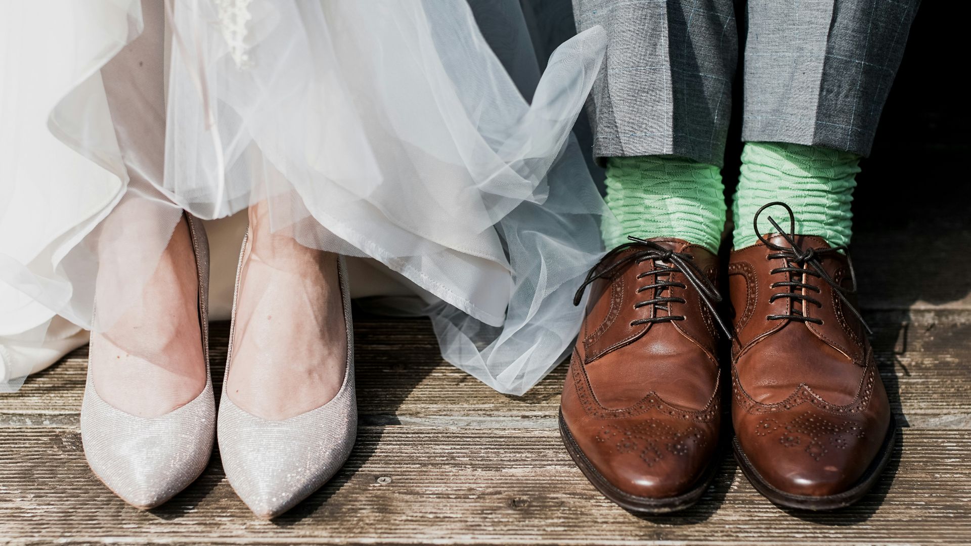 two people standing on brown wooden floor