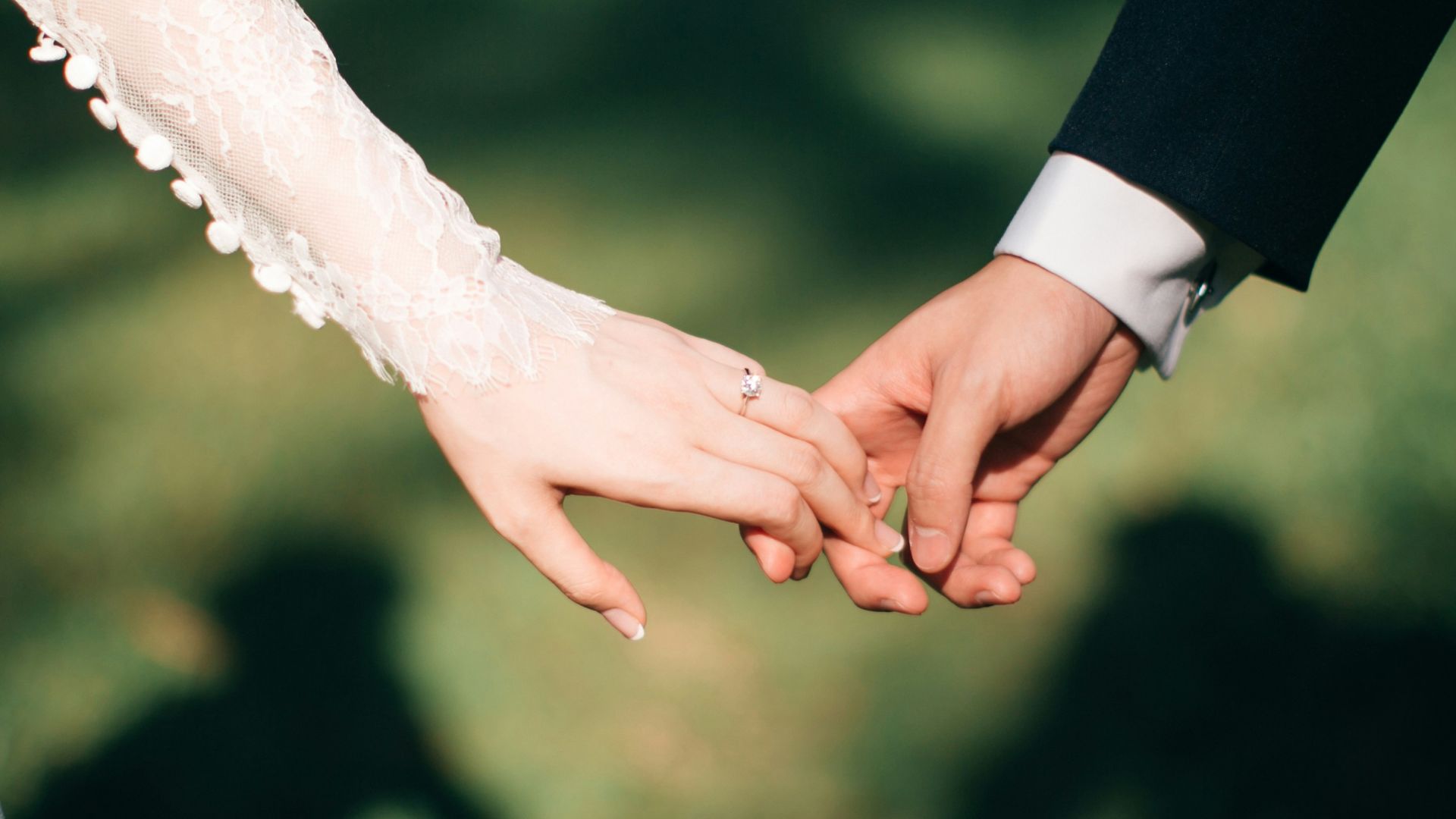 man and woman holding hands focus photo