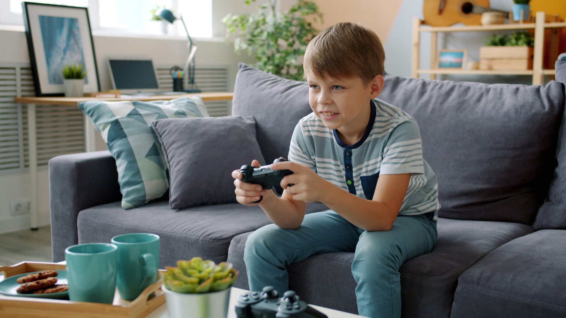 Boy playing video games on couch