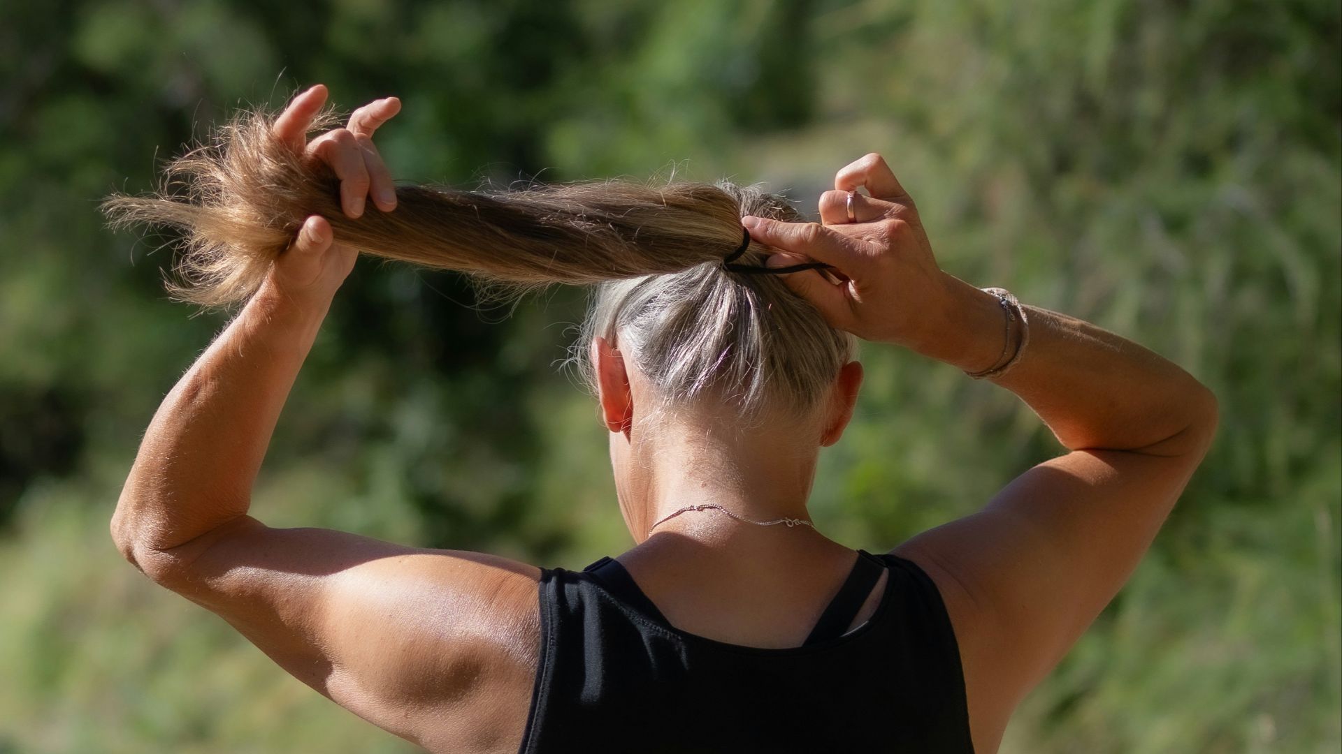 a woman with her hair in a ponytail