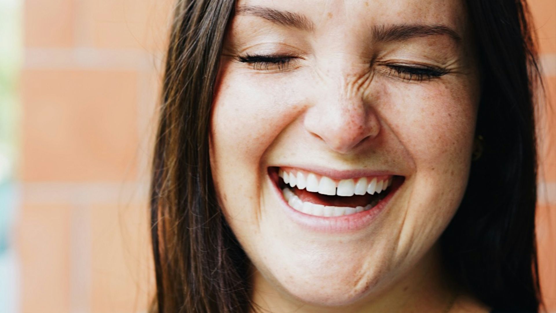 woman in black and white crew neck shirt smiling
