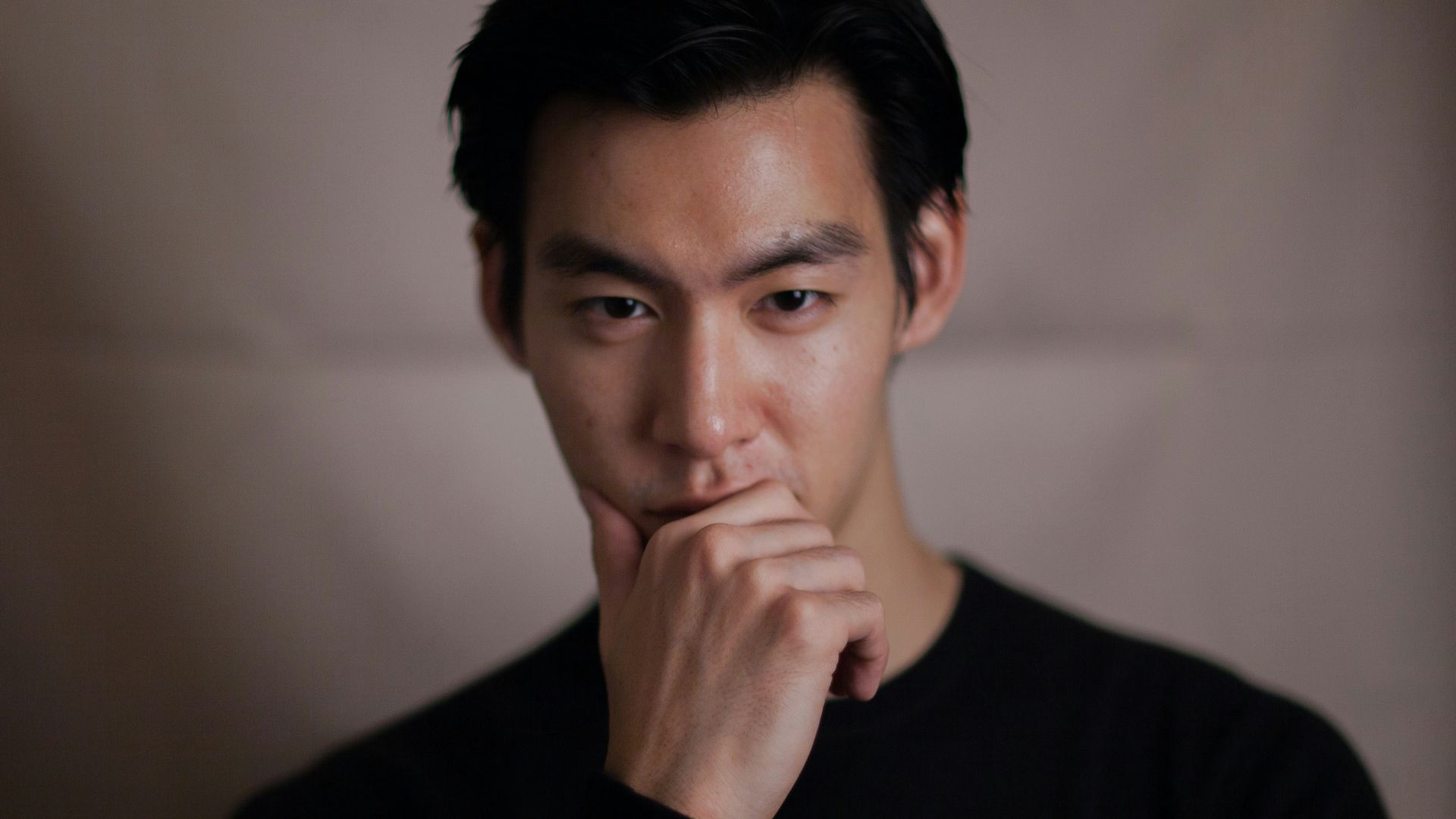 man touching his chin with right hand