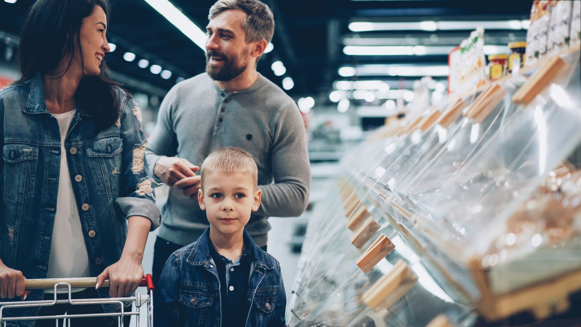 A family shops together in the grocery store.