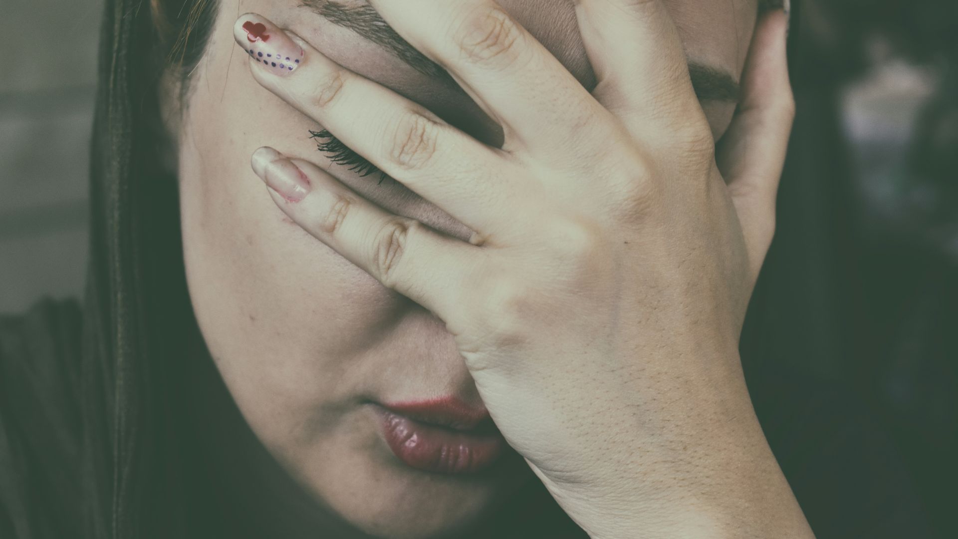 woman's hand on face