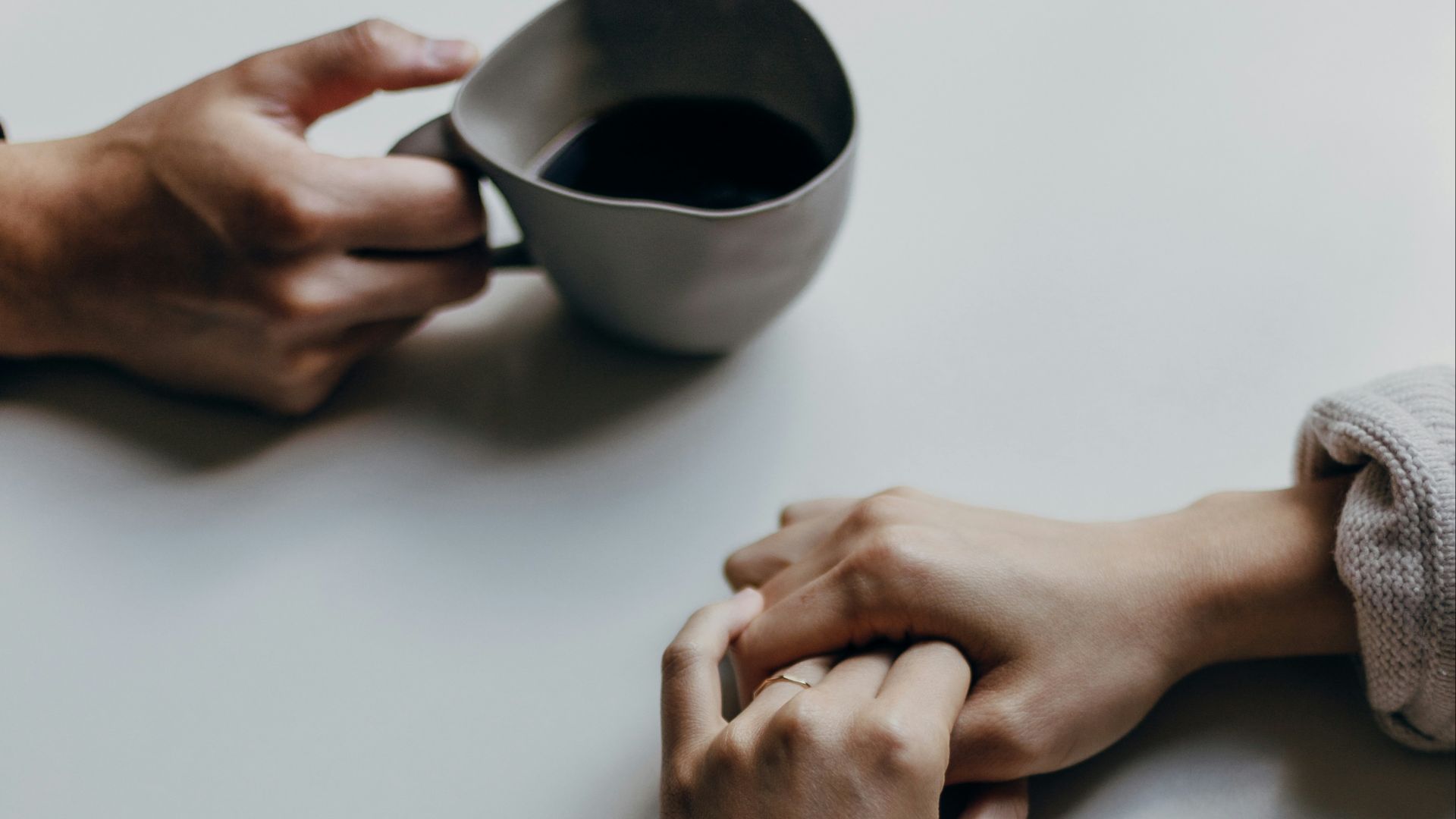 person holding black ceramic mug