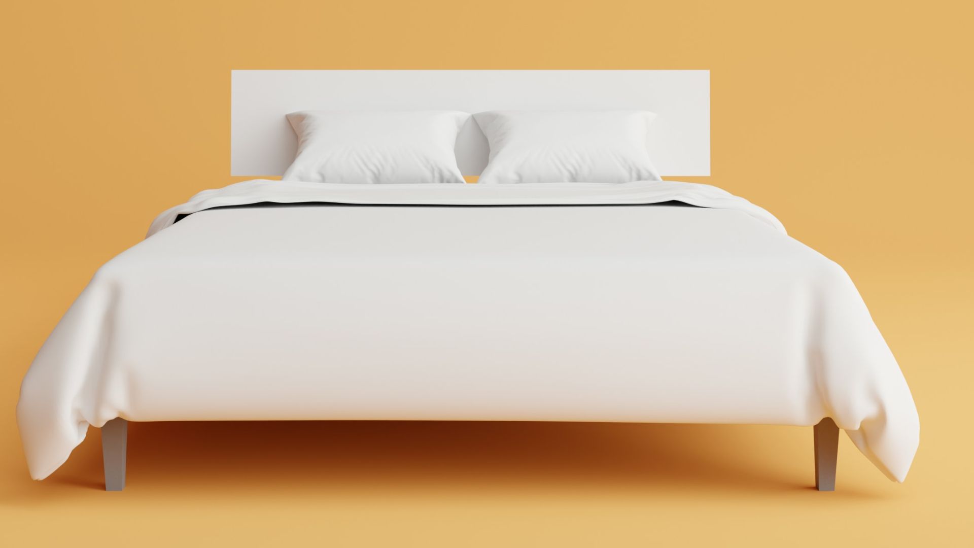 a bed with a white cover and pillows on top of it