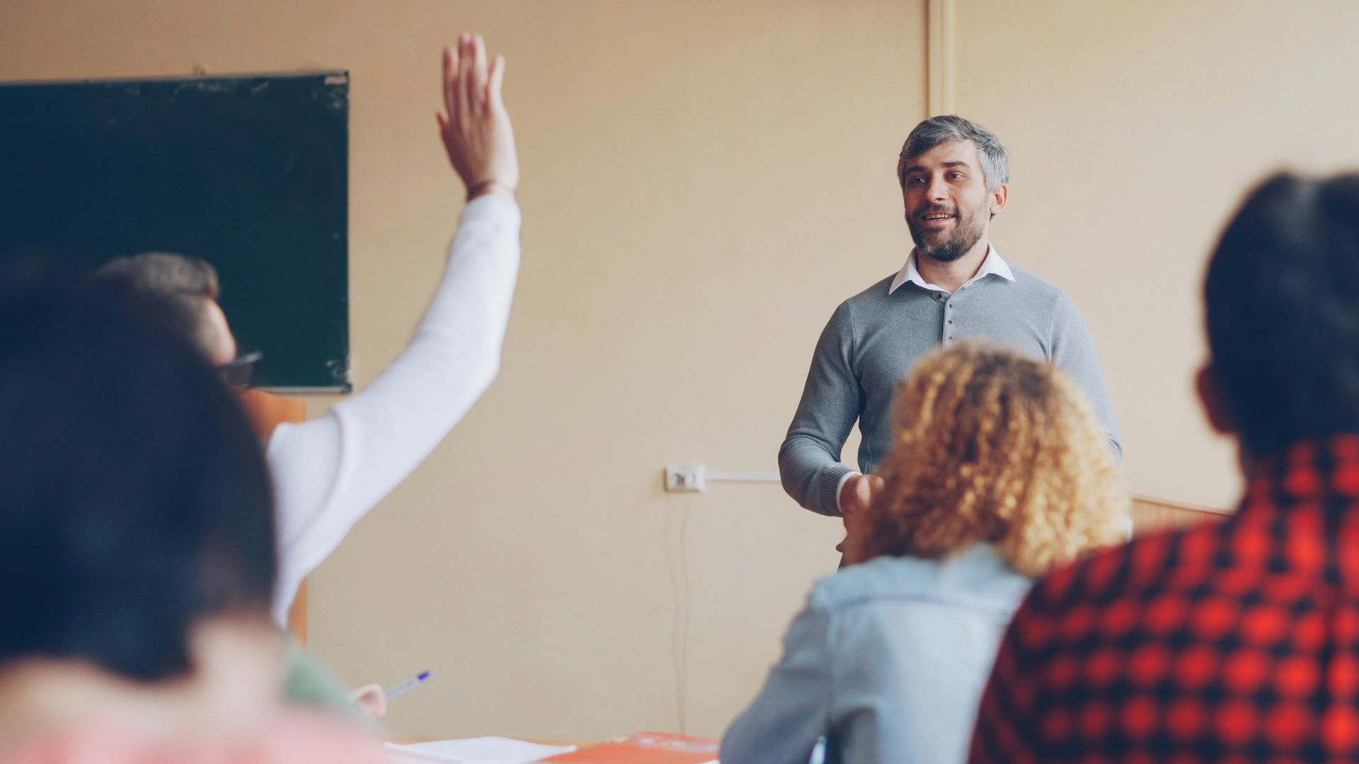 Teacher asking a question to students in a classroom.