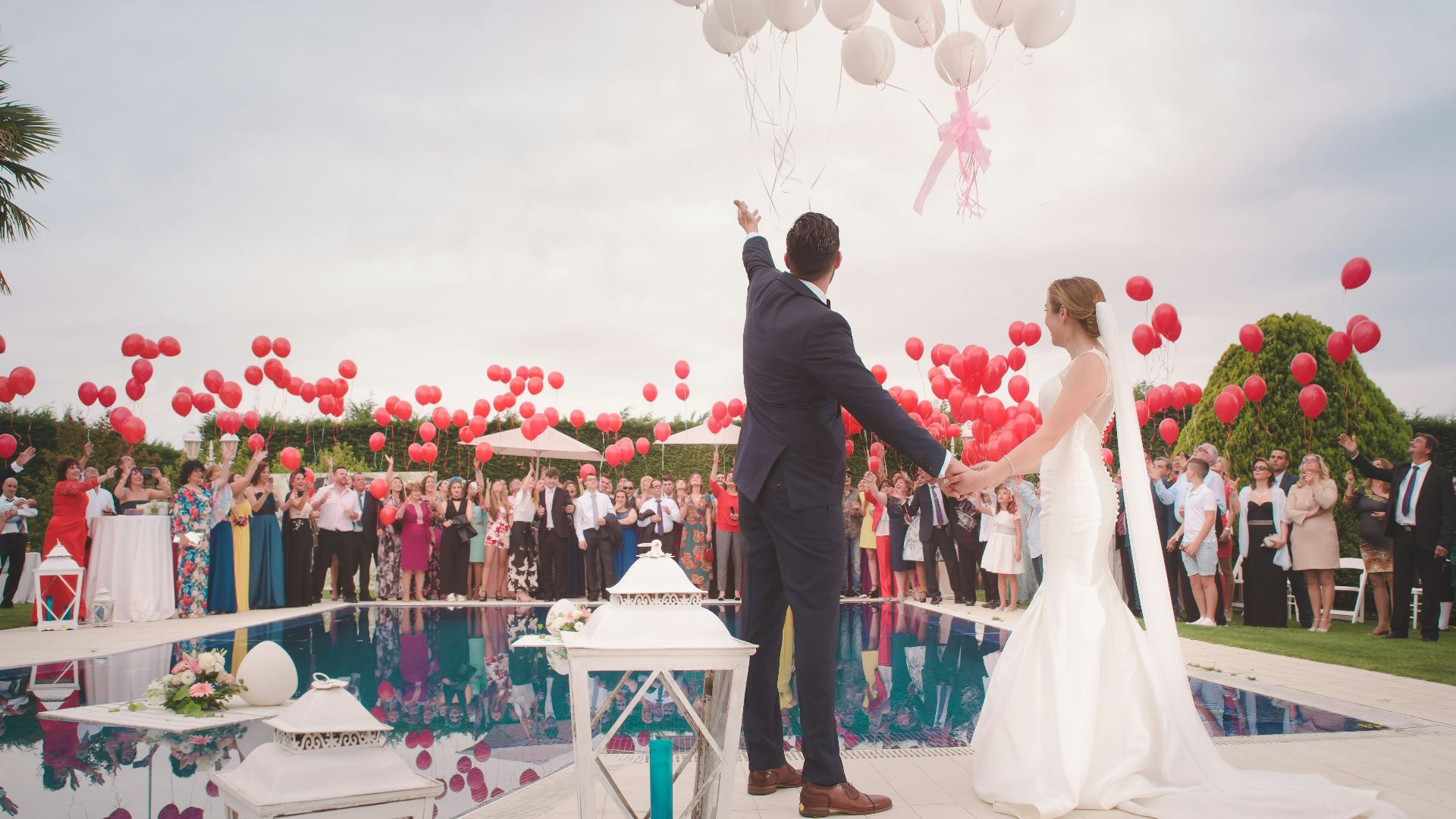 photo of a man and woman newly wedding holding a balloons