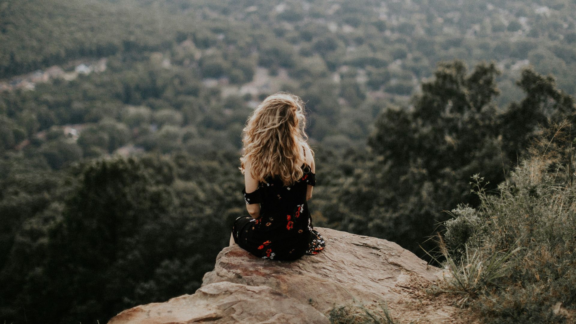 woman siting on cliff
