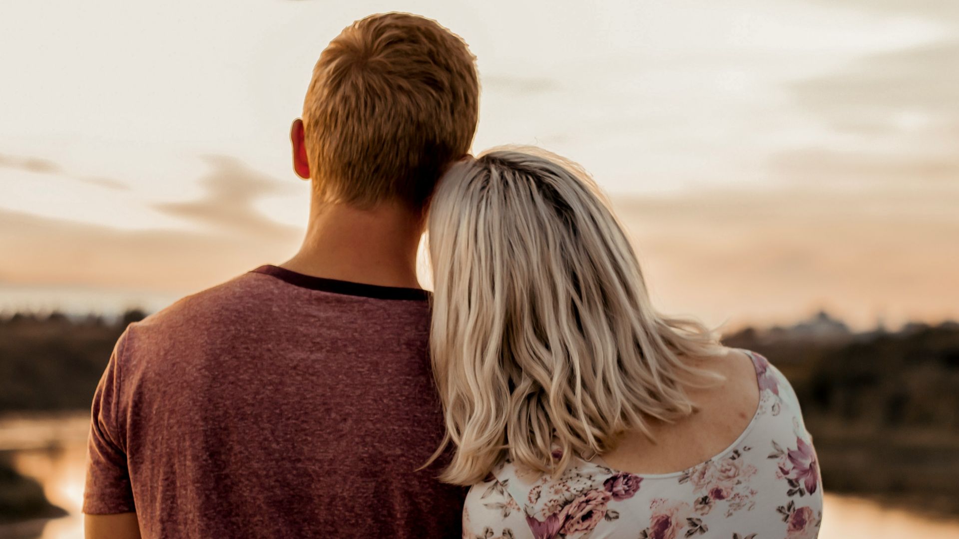man and woman standing on brown field during daytime
