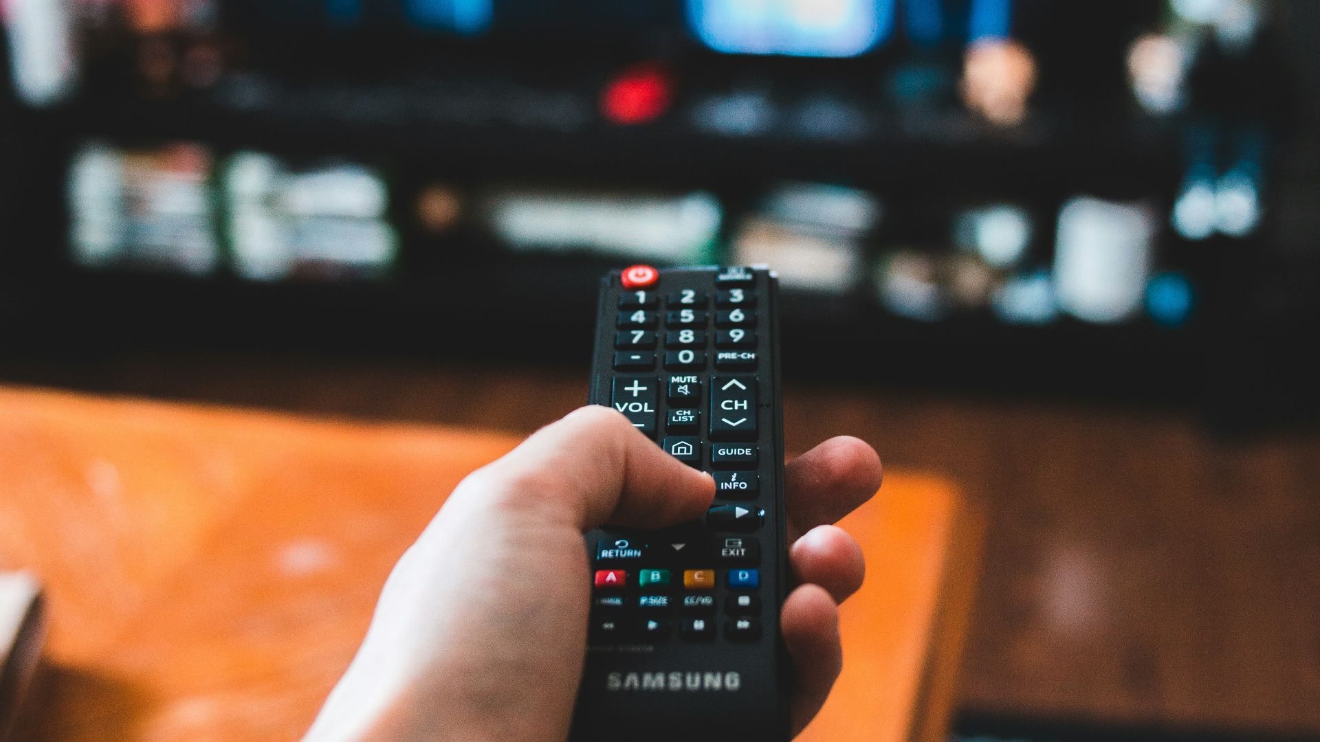 person holding black remote control