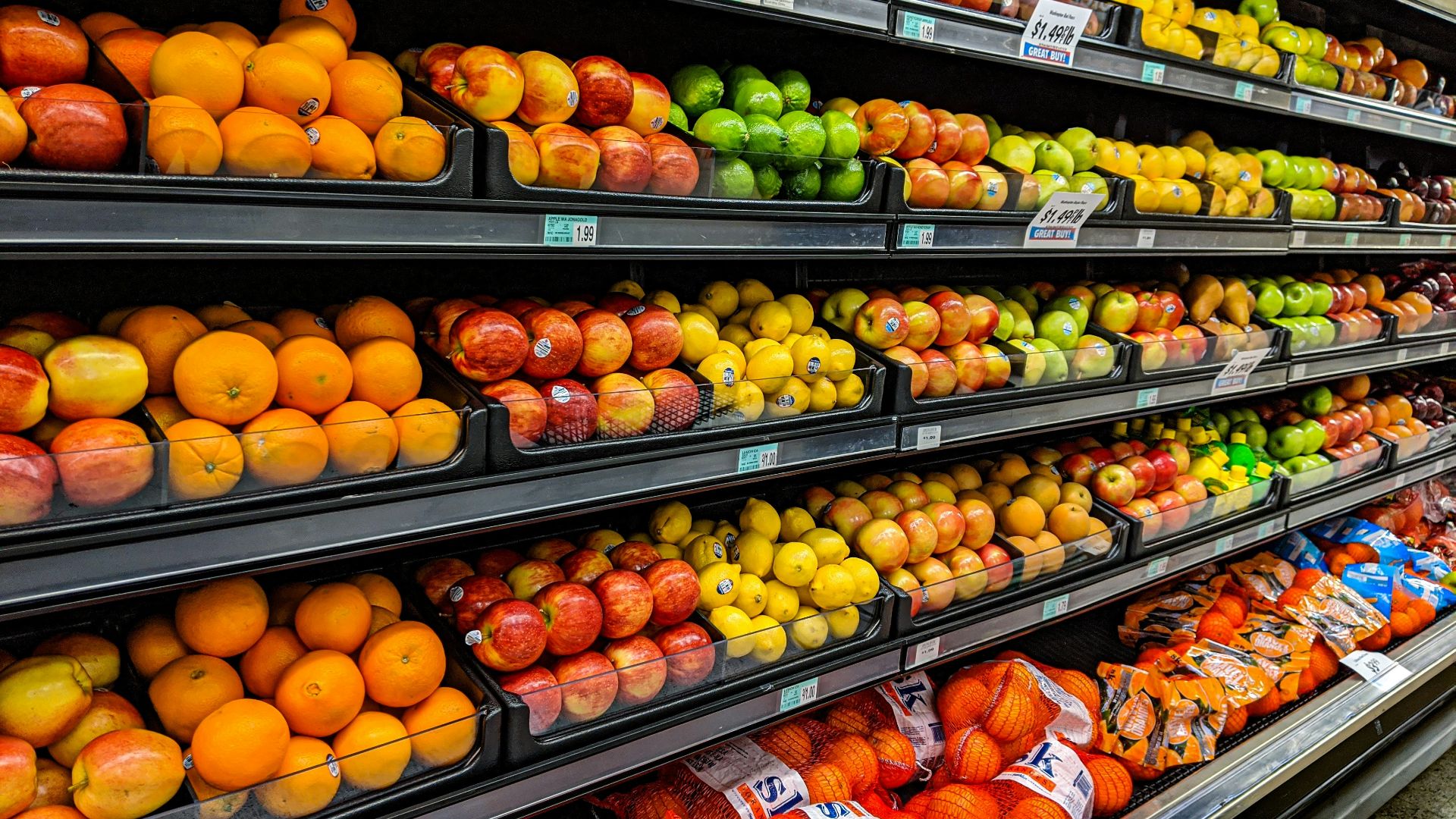 yellow and red apples on black plastic crate