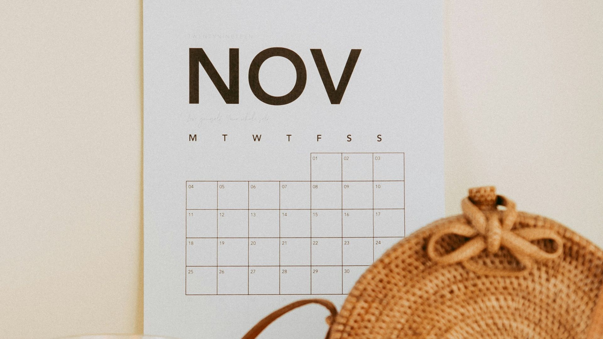 shallow focus photo of calendar mounted on white wall