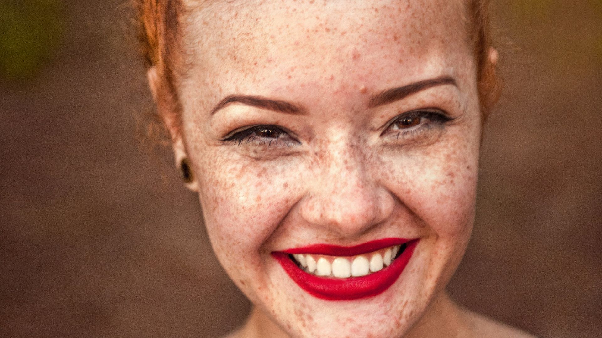 woman taking photo while showing smile