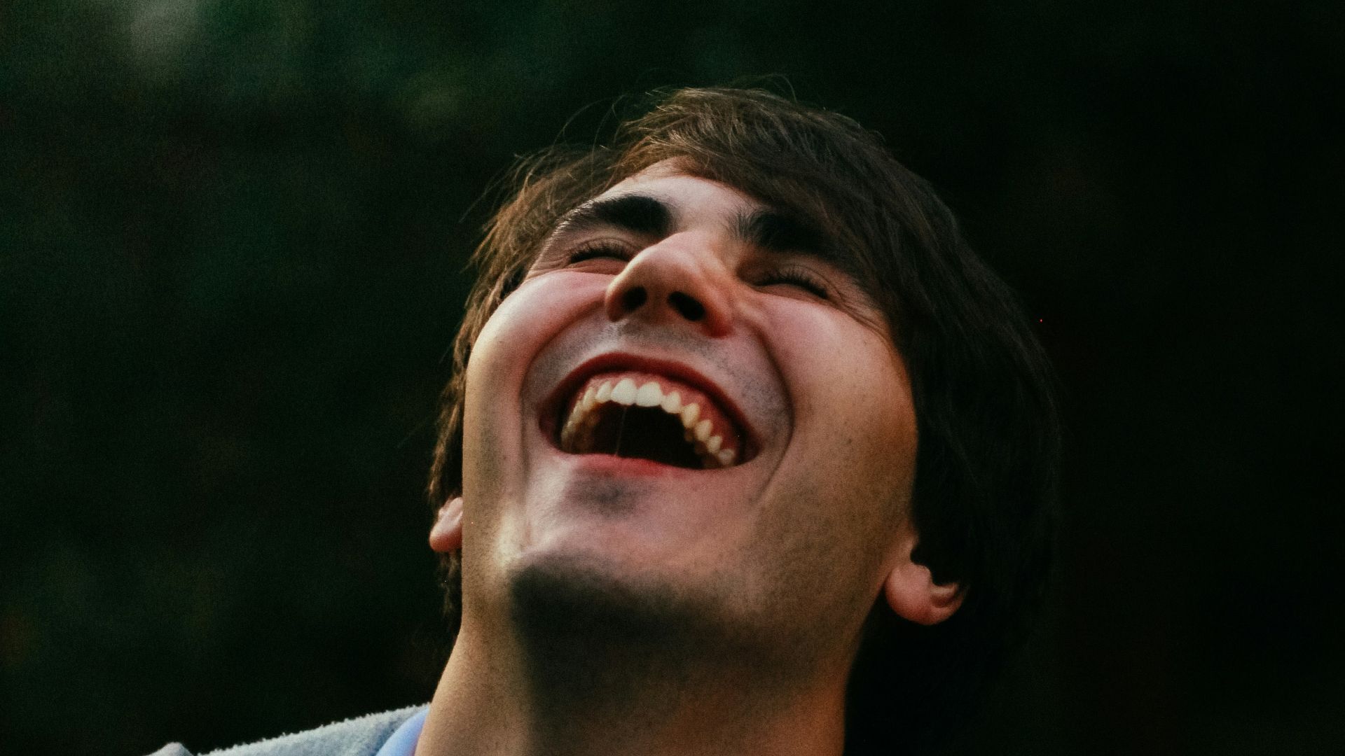 man in gray sweater smiling
