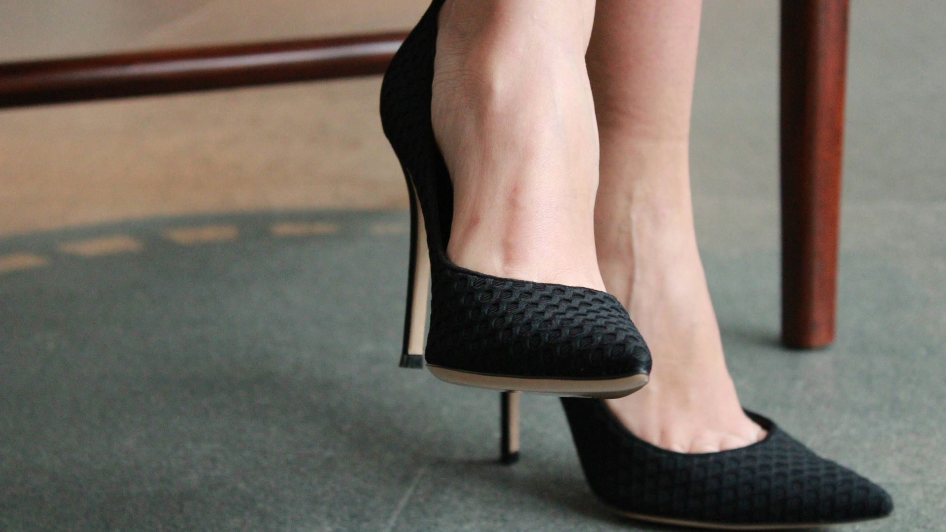 woman wearing black silettos
