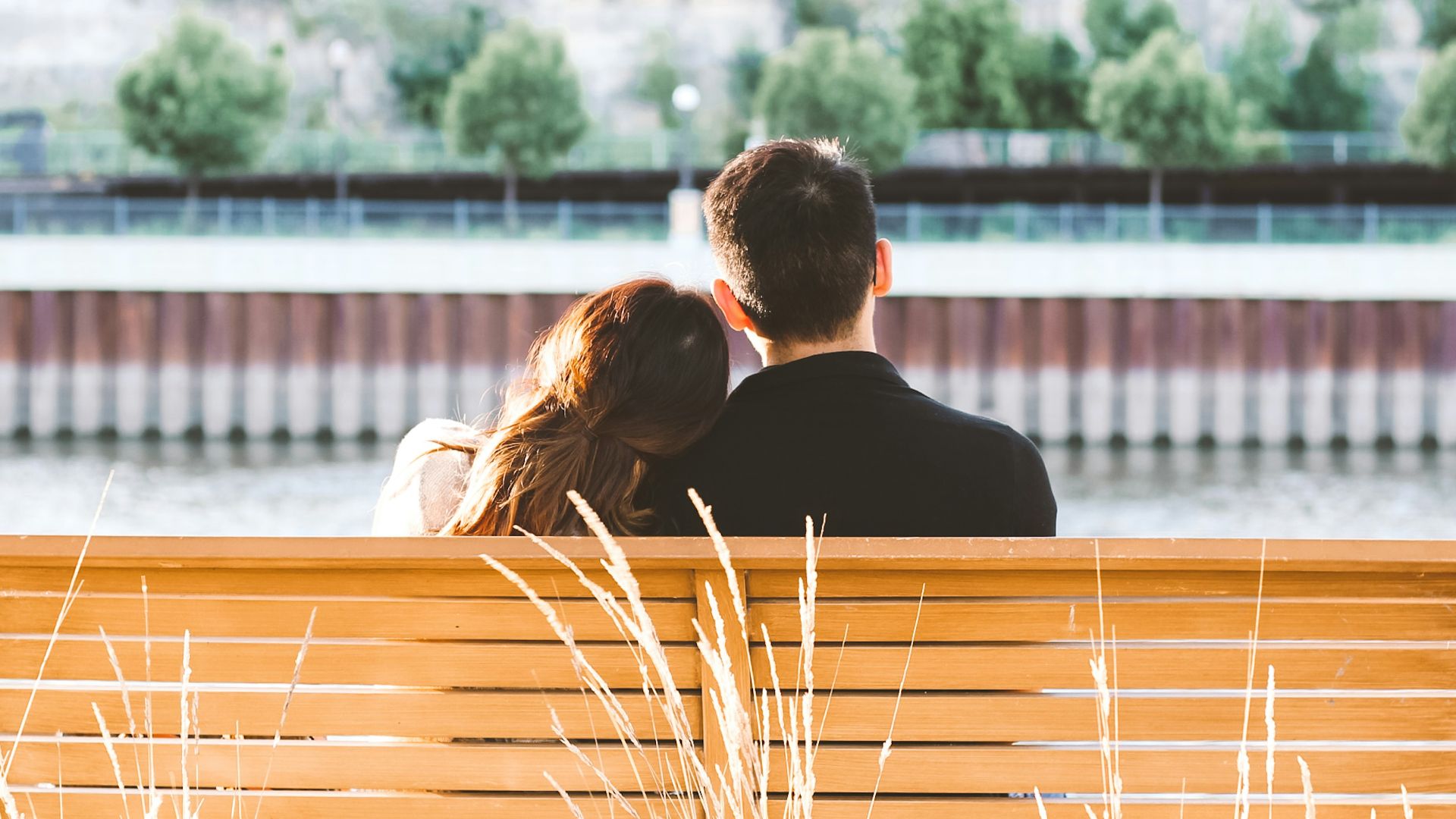 couple sitting on wooden bench