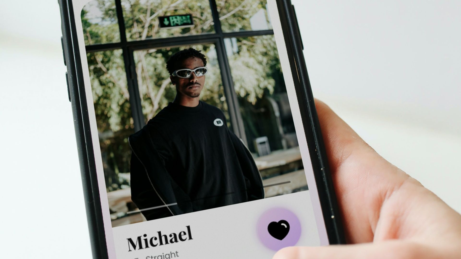 a person holding a cell phone with a picture of a man on it