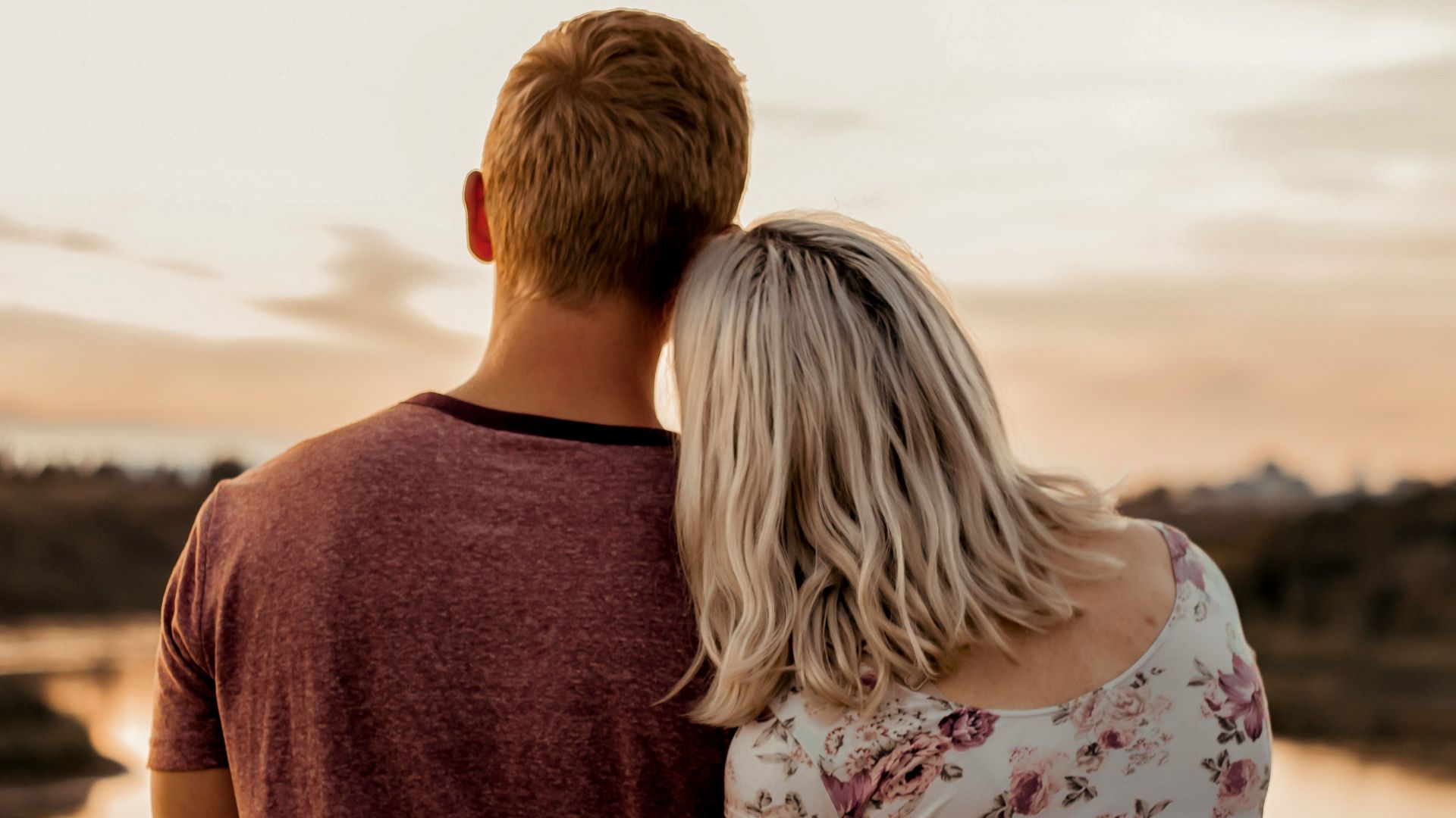 man and woman standing on brown field during daytime