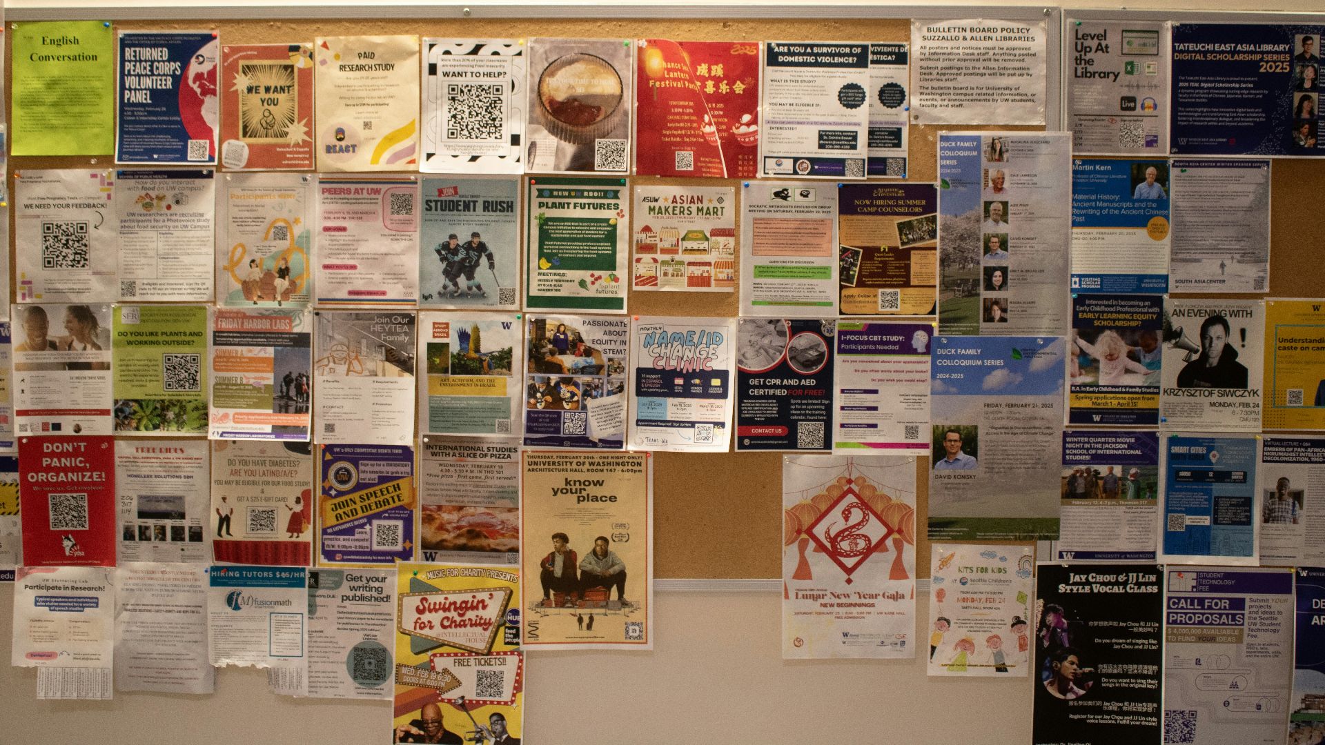 A bulletin board covered with various flyers.