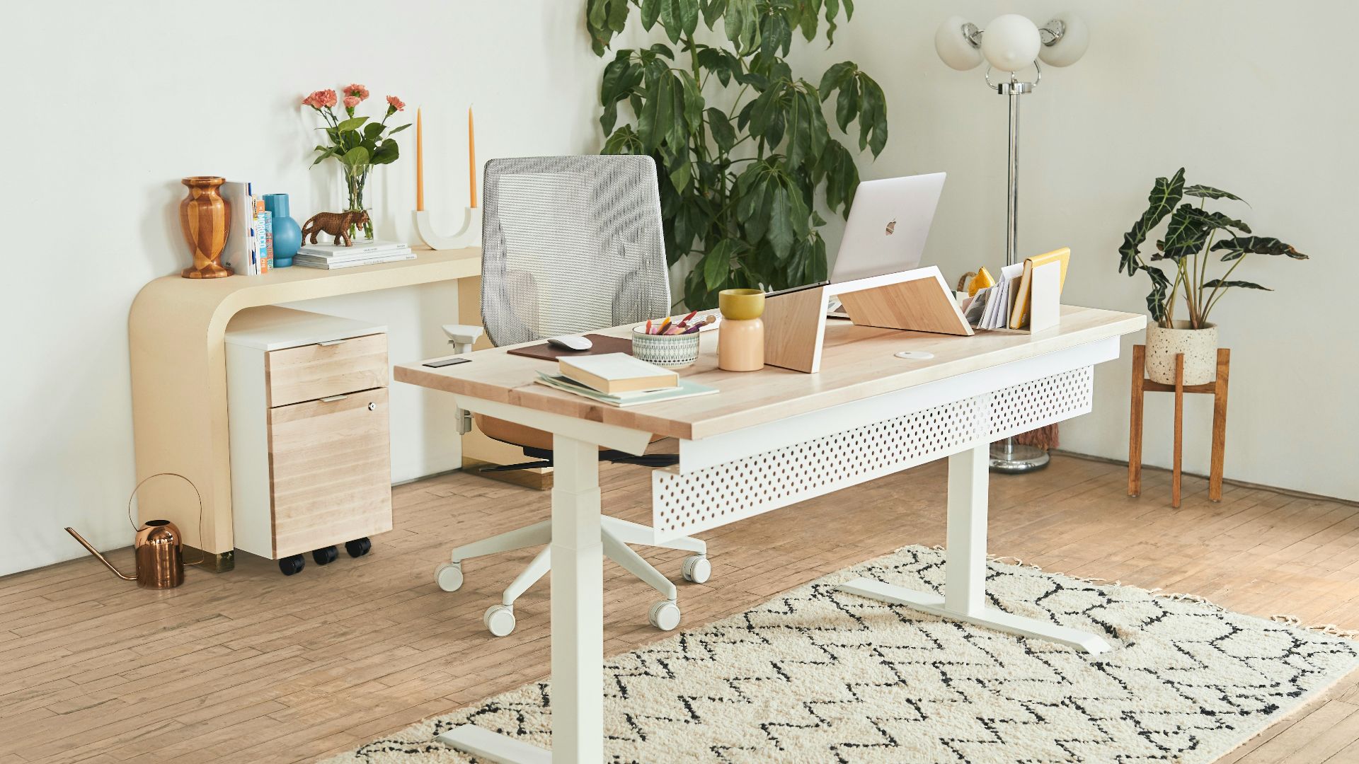 a white desk with a laptop on top of it