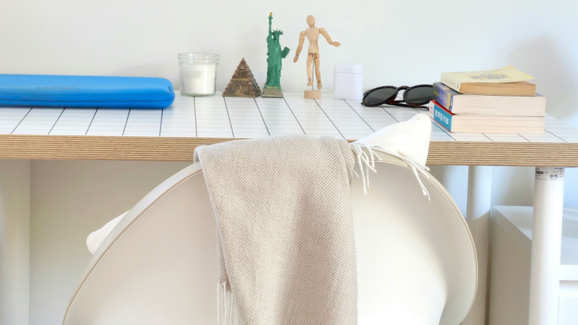 Desk with chair and assorted objects on top.