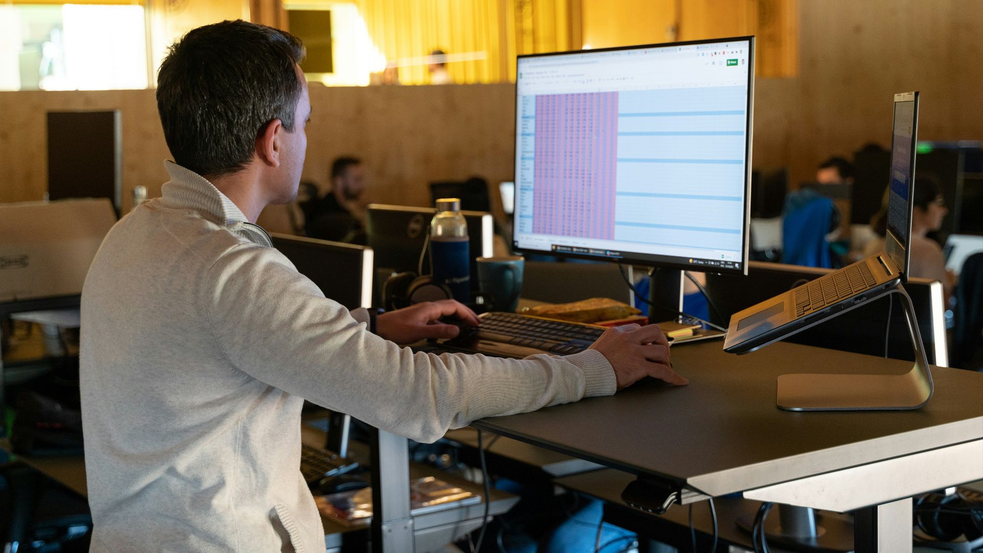 a man sitting at a desk using a computer