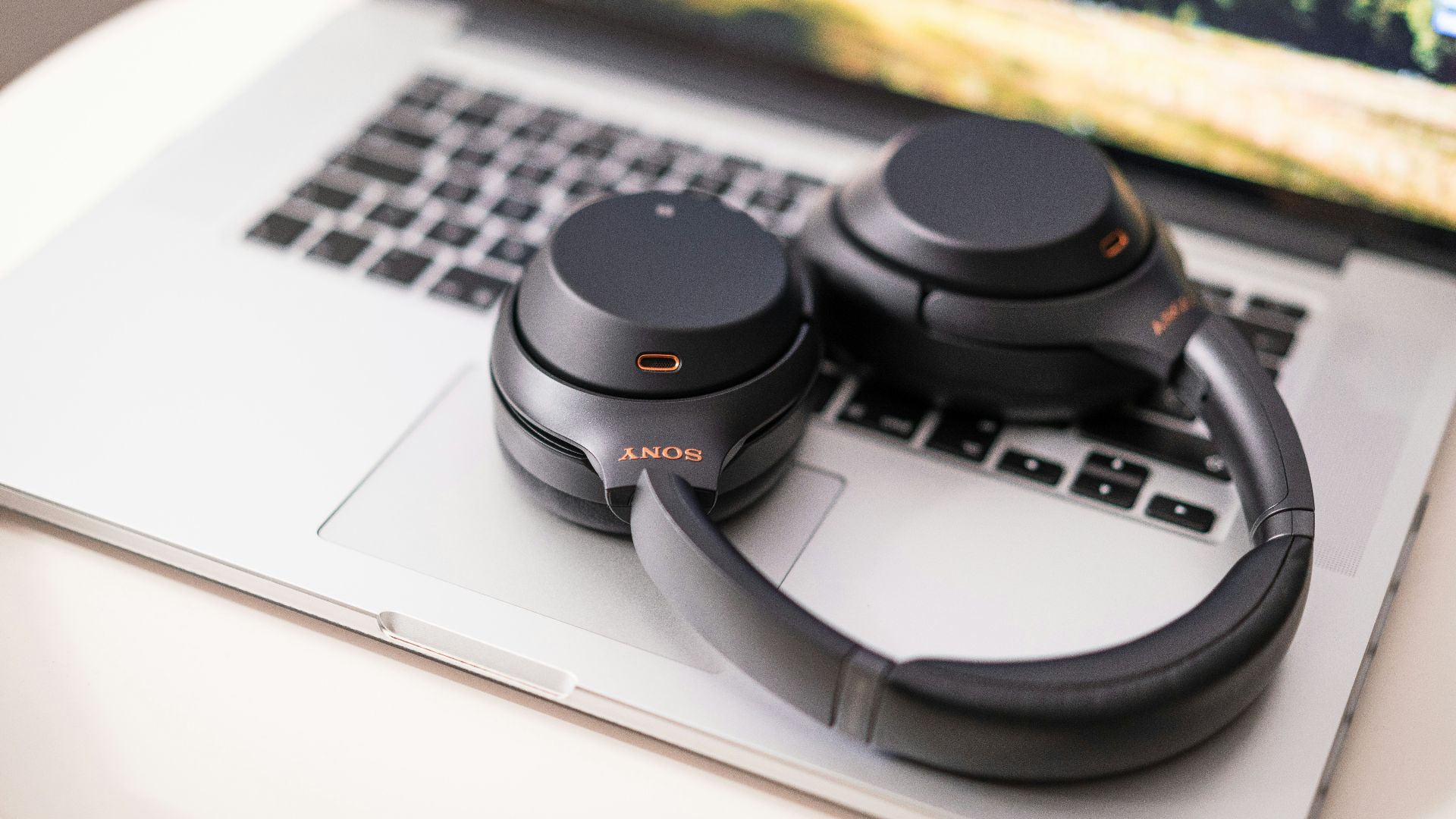 black and gray sony headphones on macbook pro