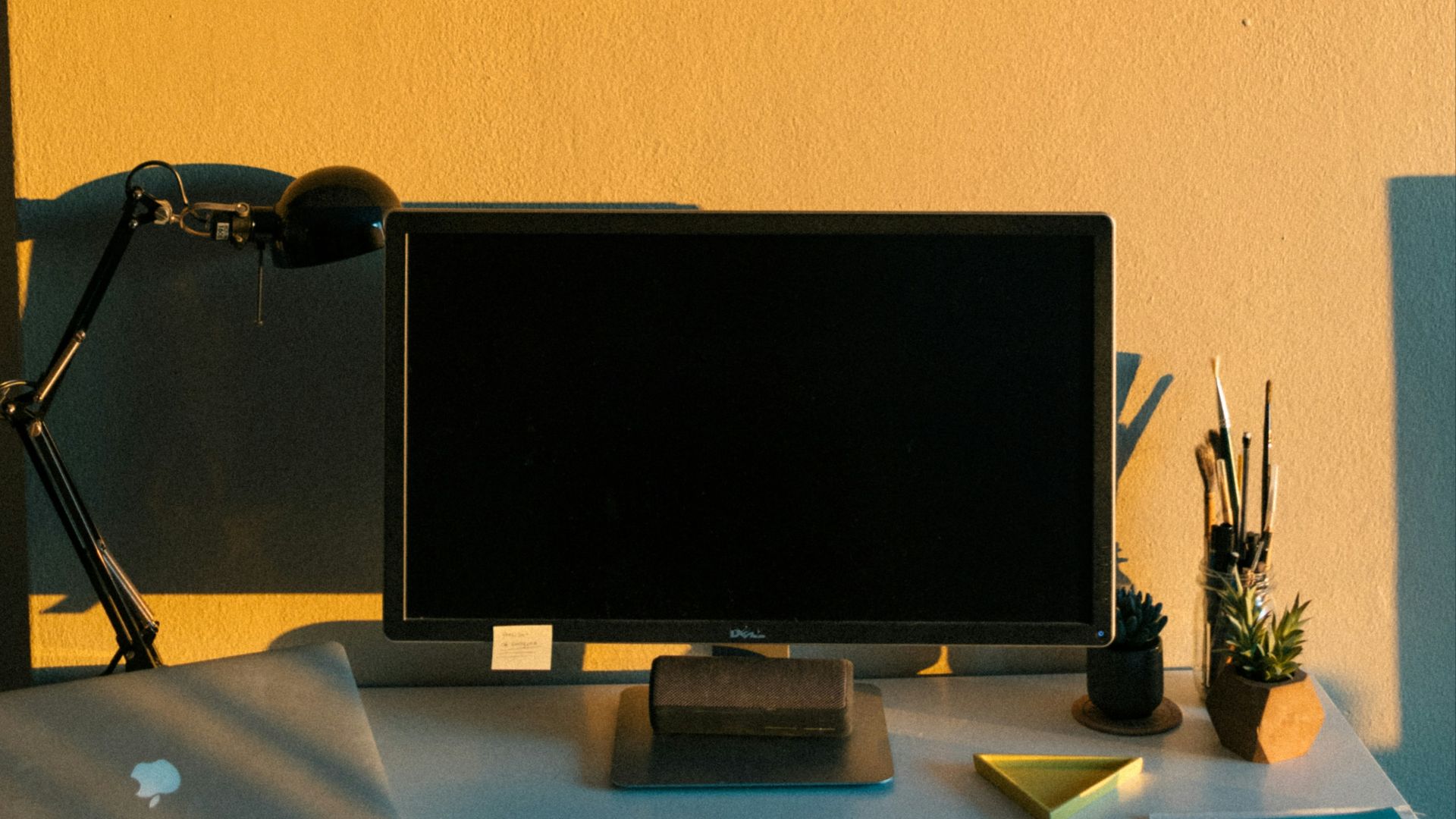 black flat screen computer monitor on brown wooden desk