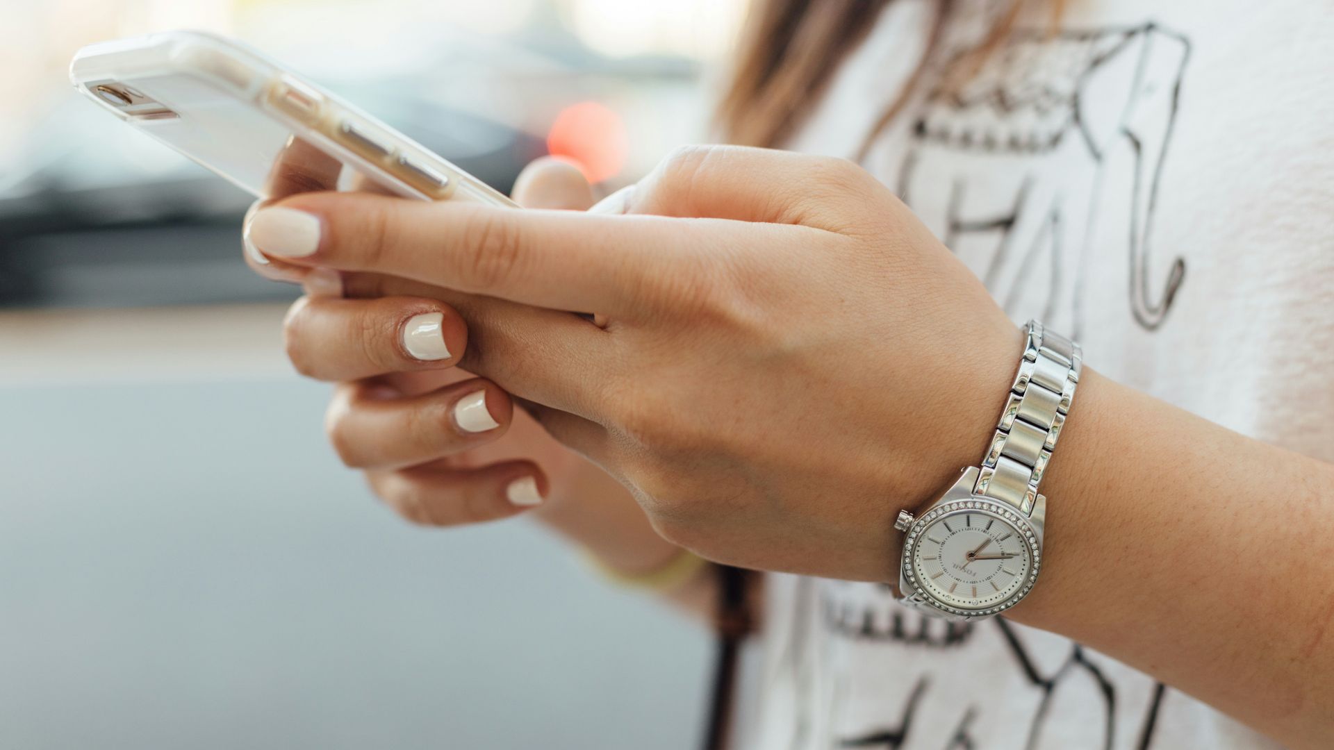 woman holding iPhone during daytime