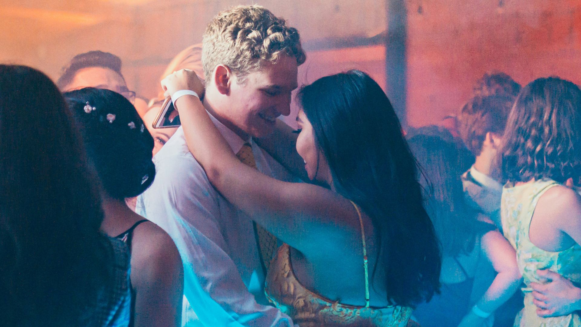woman in white sleeveless dress kissing man in blue dress shirt