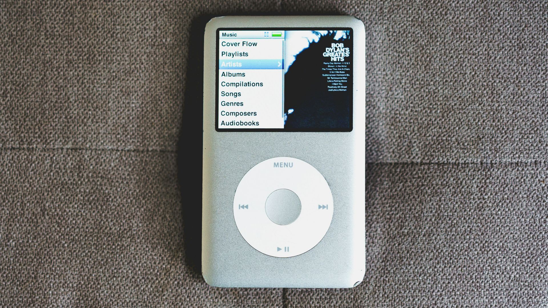 an ipod sitting on top of a couch